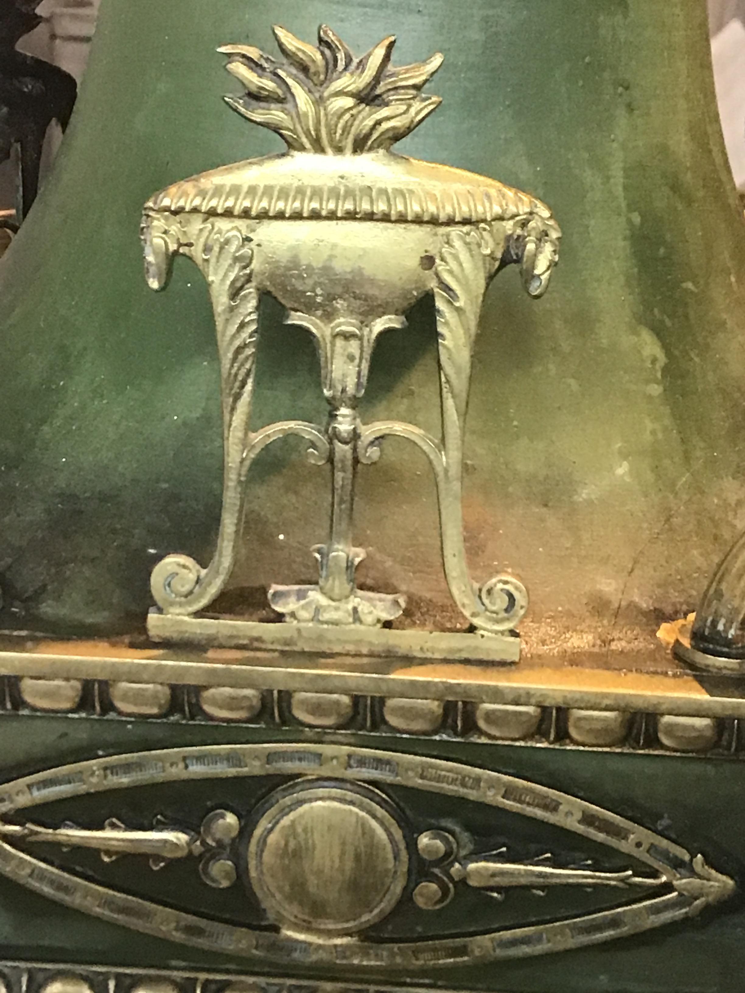 1920s brass with green finish classical chandelier. Adorned with urns of fire with ram heads. I’ve never seen this model before. Very special.