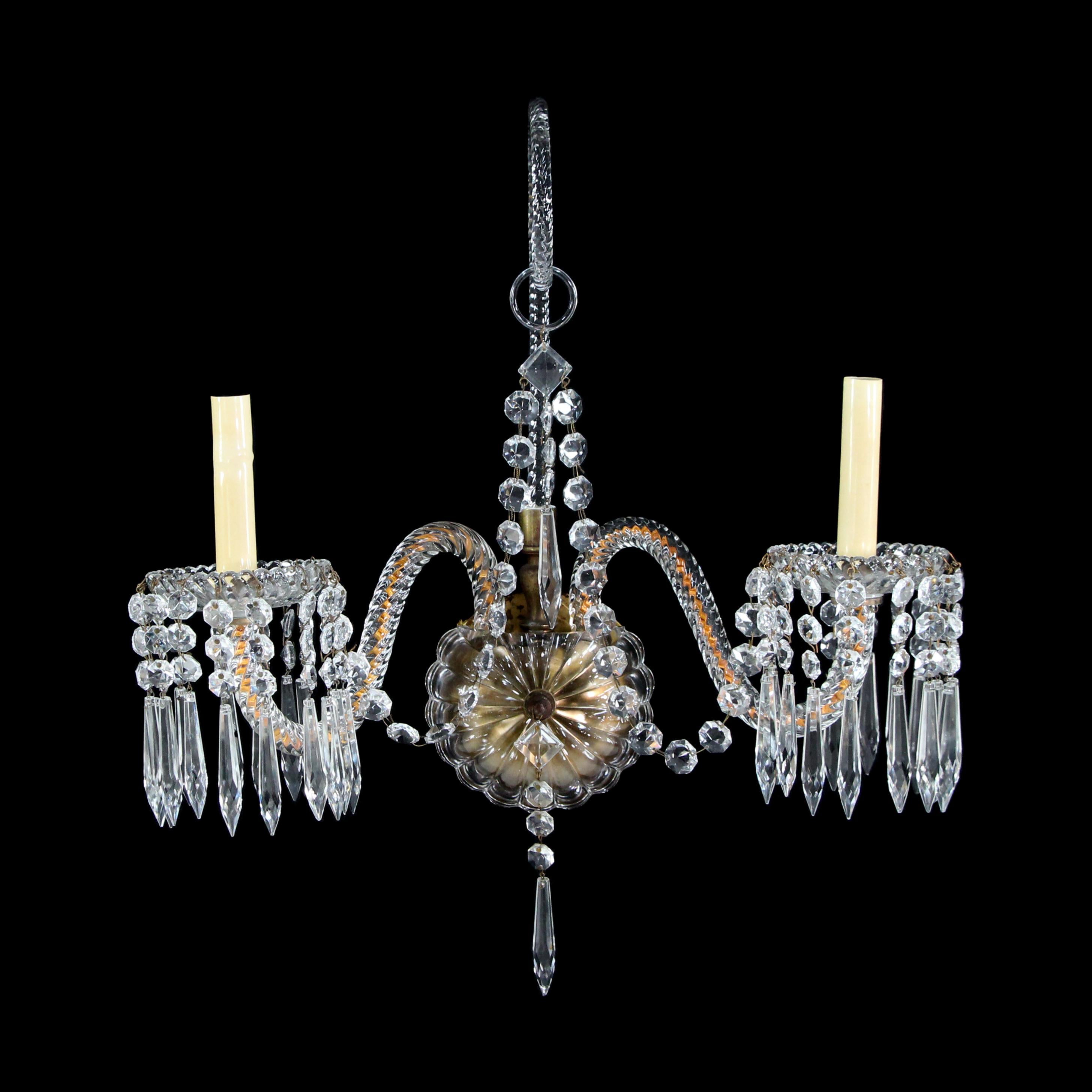 Elegant 1920s two-arm crystal sconce from historic NYC hotel. The sconce feature two crystal glass 