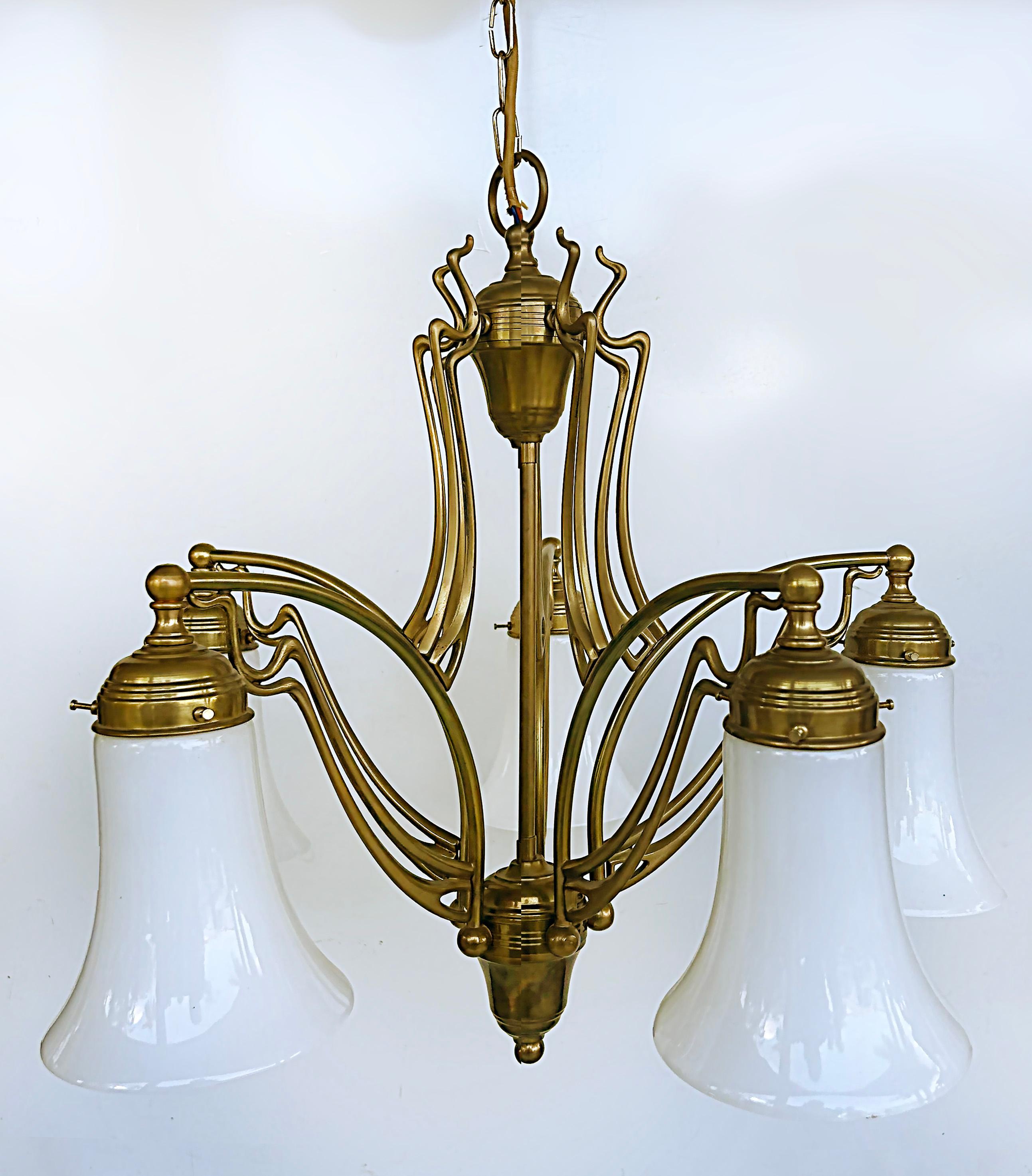 1920s Bronze Art Nouveau German 5-Arm Chandelier, Milk Glass Shades 

Offered for sale is a German Art Nouveau bronze and milk glass five-arm chandelier. The owner acquired this chandelier while living in the Charlottenburg area of Germany and