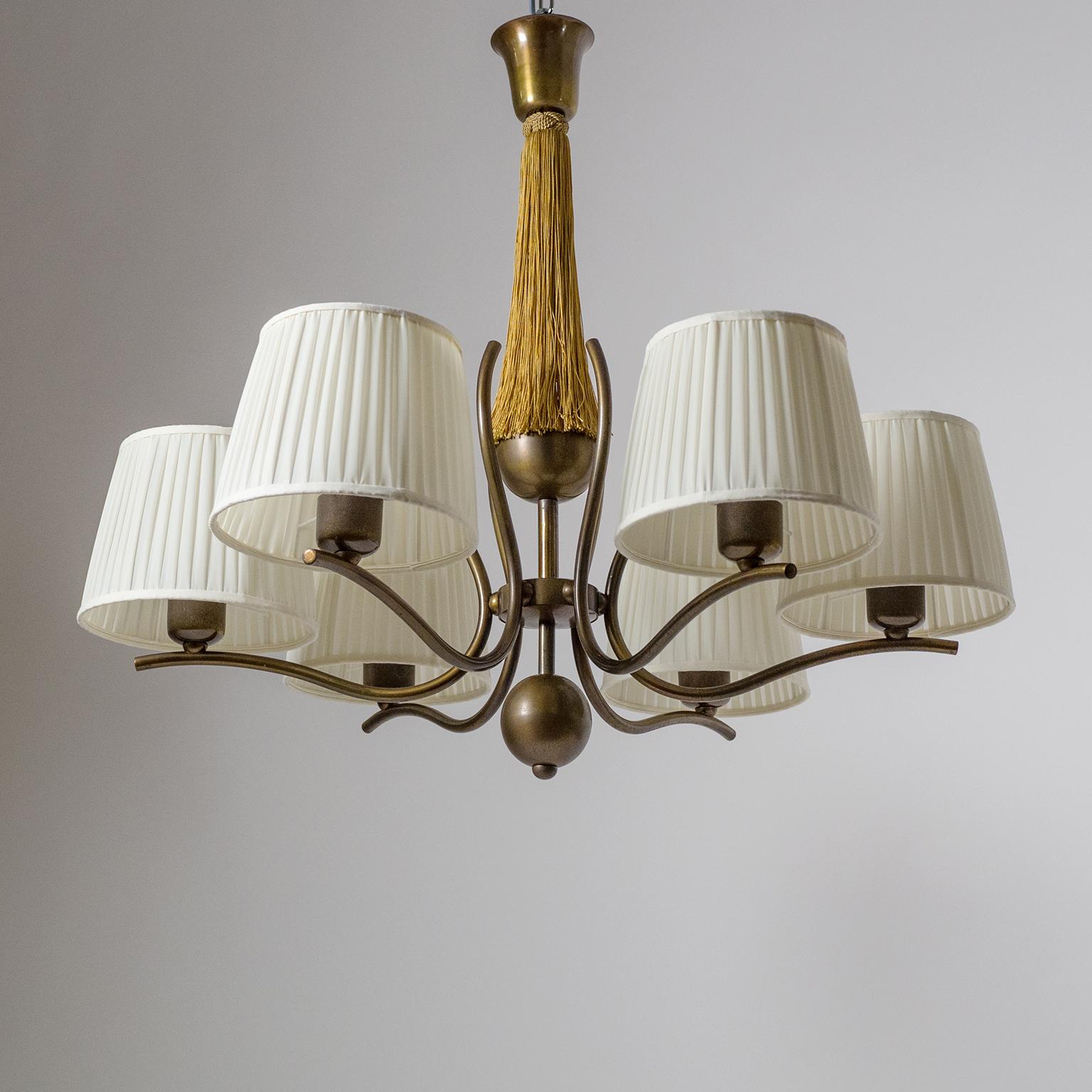 Graceful six-arm bronze chandelier from the 1920s with large pleated fabric shades. Very high quality craftmanship likely produced by J.T. Kalmar. Dark bronze structure with elegantly curved arms and a Fine Minimalist Art Deco design. The stem has