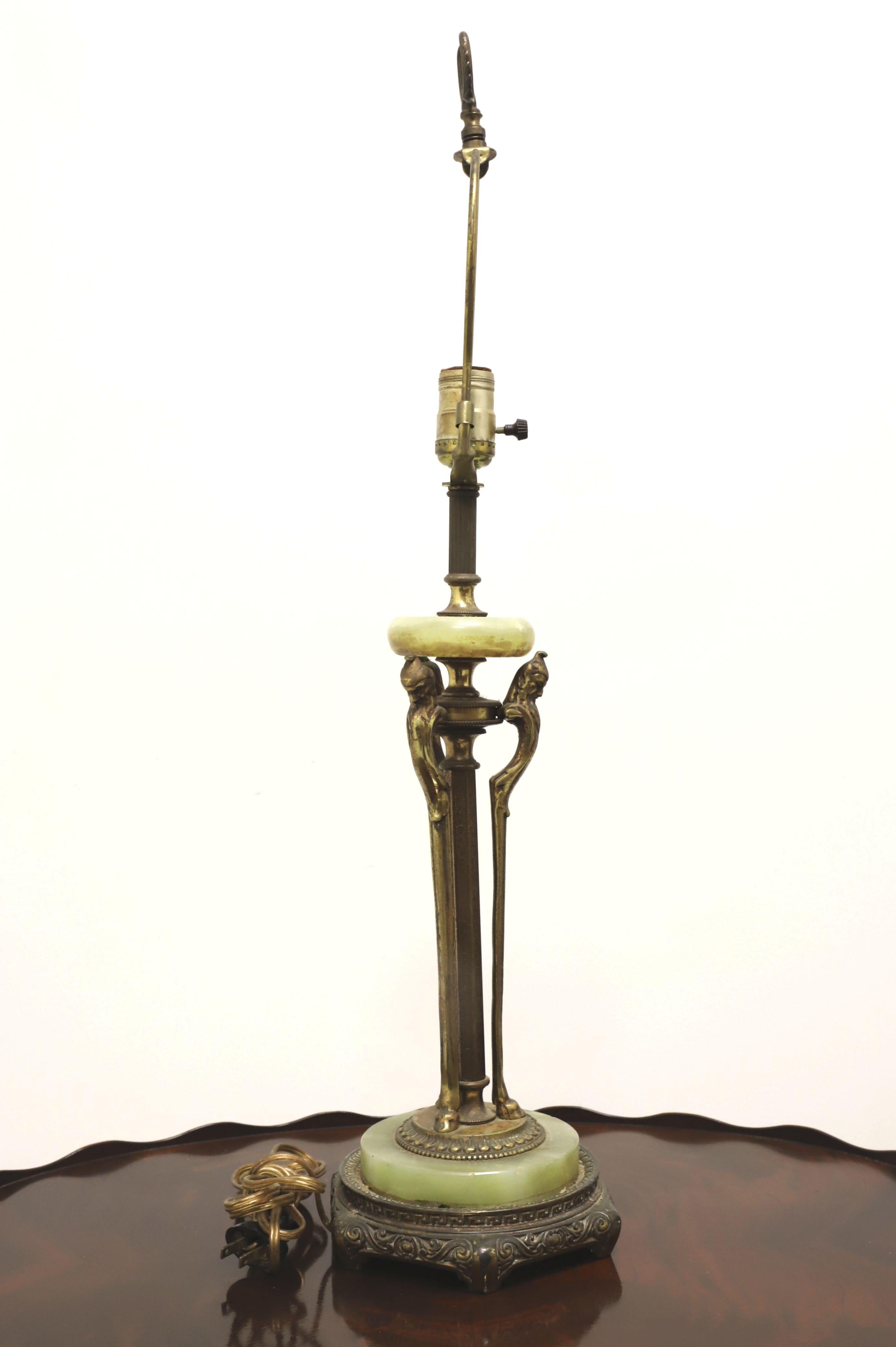 An antique Art Deco style table lamp, unbranded. Slender bronze form supporting a small round polished green marble piece at top, a larger round polished green marble piece at bottom and a bronze base. Single standard bulb socket with 3-way knob