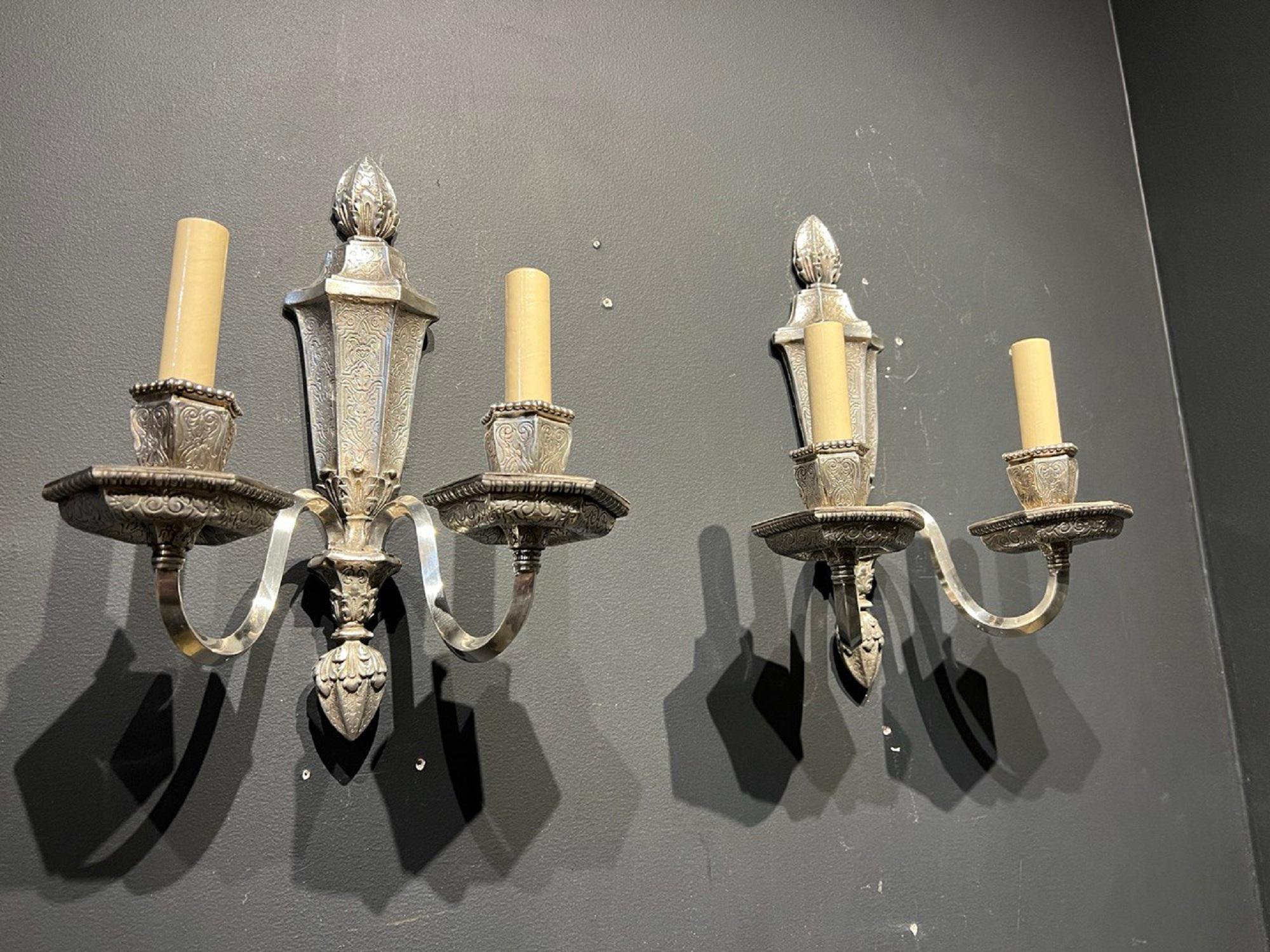 A pair of 1920’s Caldwell silver plated sconces with neoclassical design 