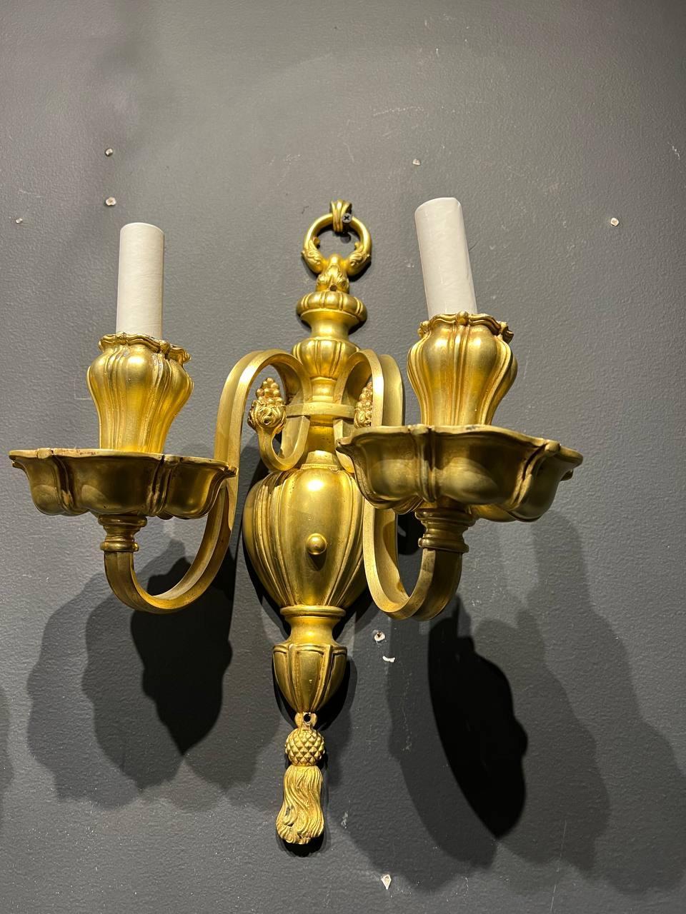 A pair of circa 1920’s Caldwell gilt bronze sconces with two lights