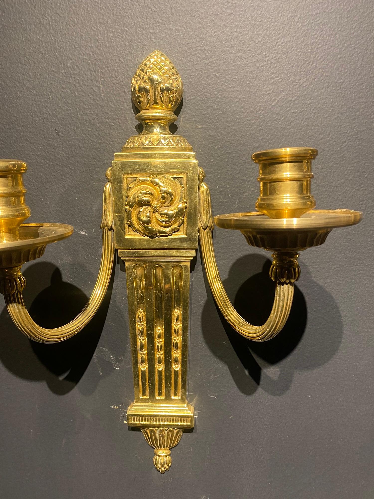 A pair of circa 1920’s Caldwell neoclassic style gilt bronze sconces with two lights