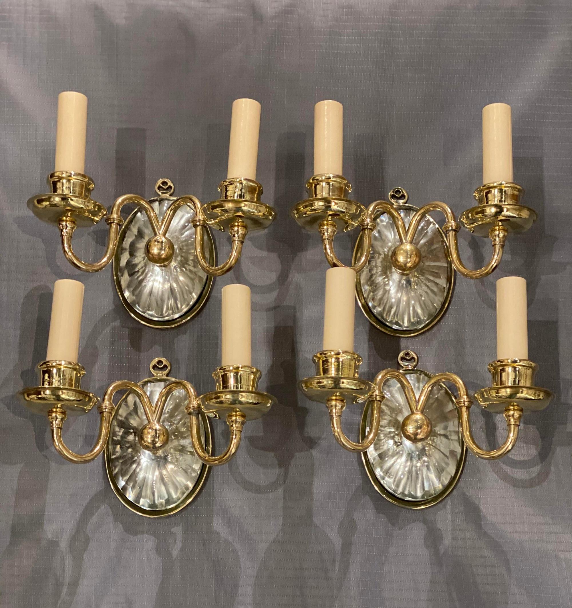 A pair of circa 1920’s gilt bronze and mirrored backplate Caldwell sconces. Small size.
