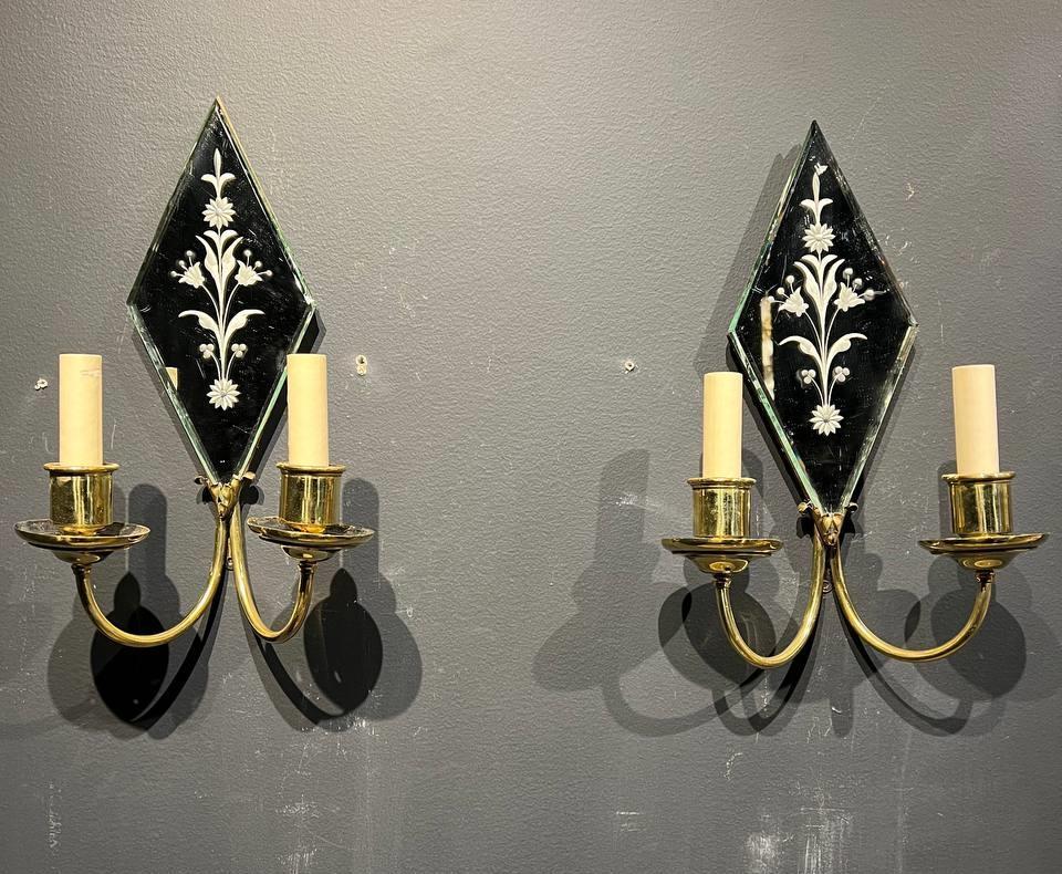 A circa 1920's mirrored sconces with flowers design and two arms for lights