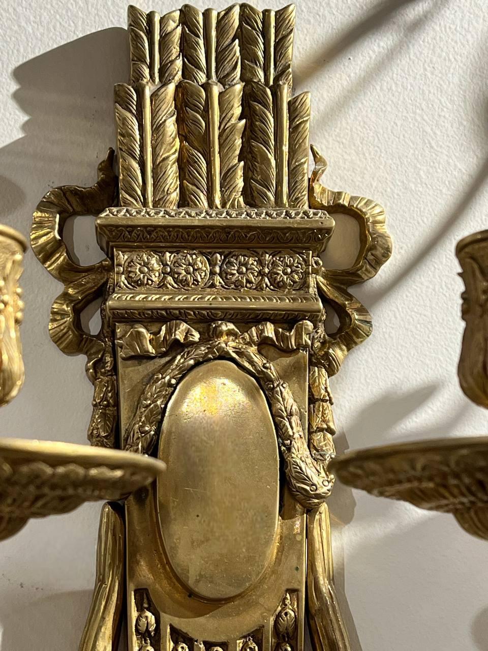 A pair of 1920’s gilt bronze Caldwell neoclassical engraved sconces with two lights