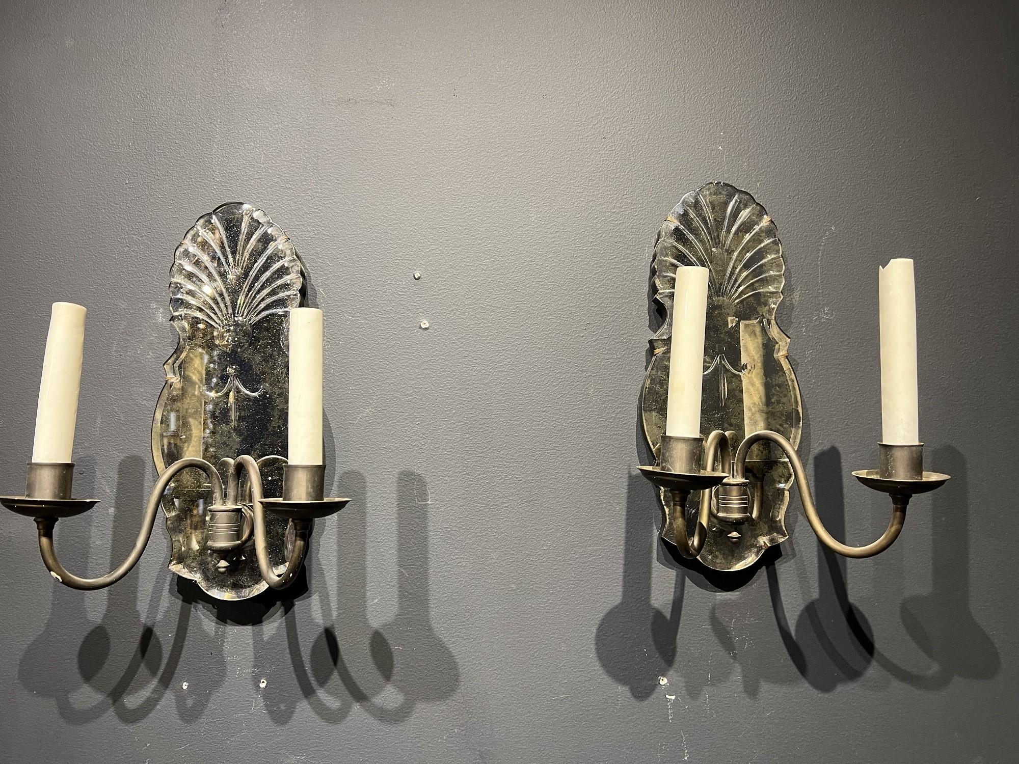 A pair of circa 1920's Caldwell brown patina bronze sconces with etched mirrors and two lights