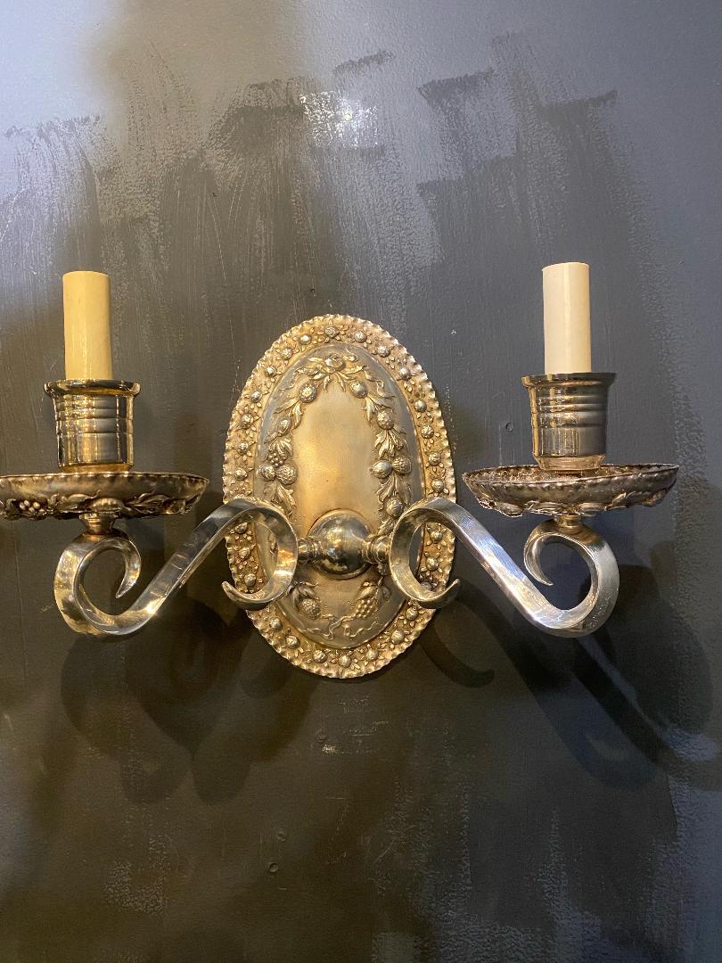 A pair of circa 1920's silver plated double light Baroque style sconces with unusual hazelnuts design.