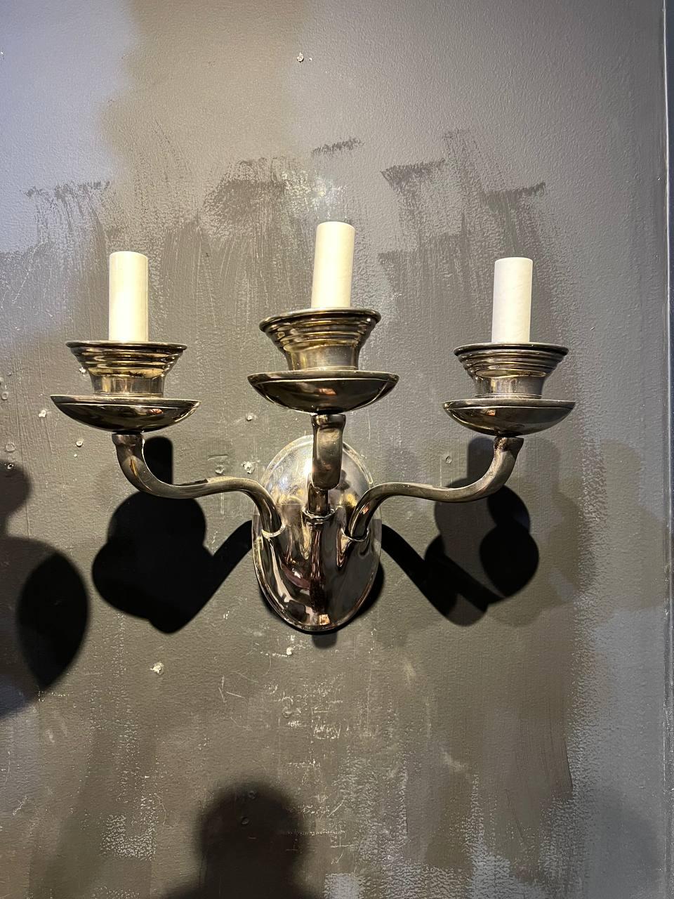 A pair of circa 1920’s Caldwell silver plated 3 lights sconces