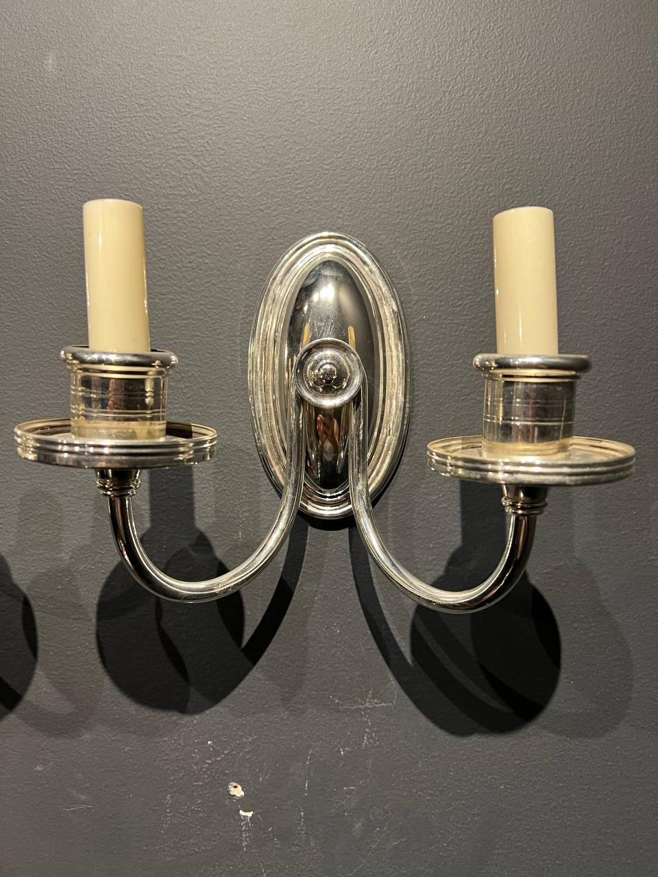 A circa 1920s Caldwell silver plated bronze sconces with two arms