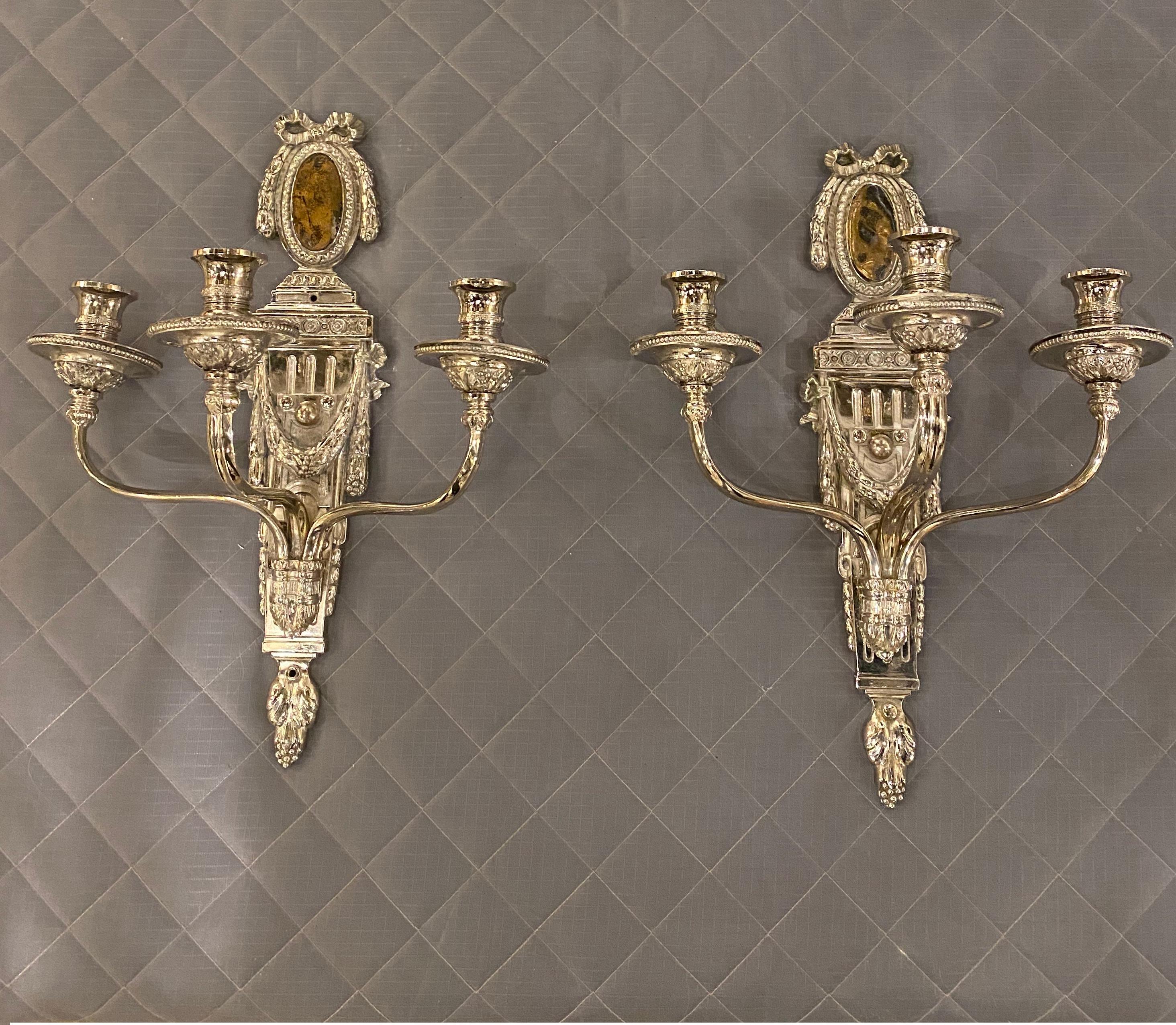 A pair of circa 1920’s Caldwell silver plated sconces neoclassical style with three lights