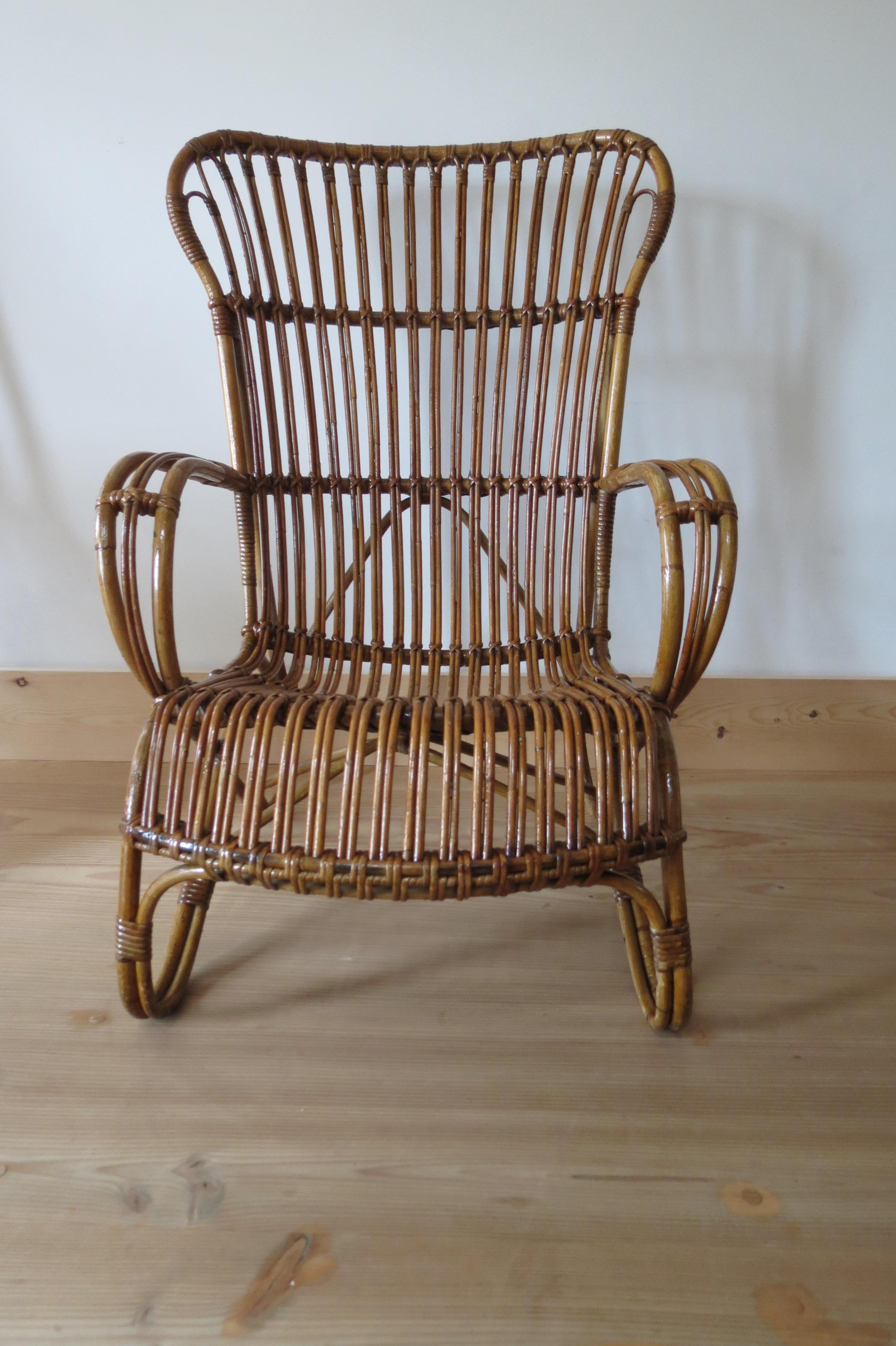 Lounge chair from the 1920s made from steam bent cane and rattan. 
Good overall condition.
Similar smaller chair is also available.
Measures: 100 cm T, 70cm W, 77cm D.
 