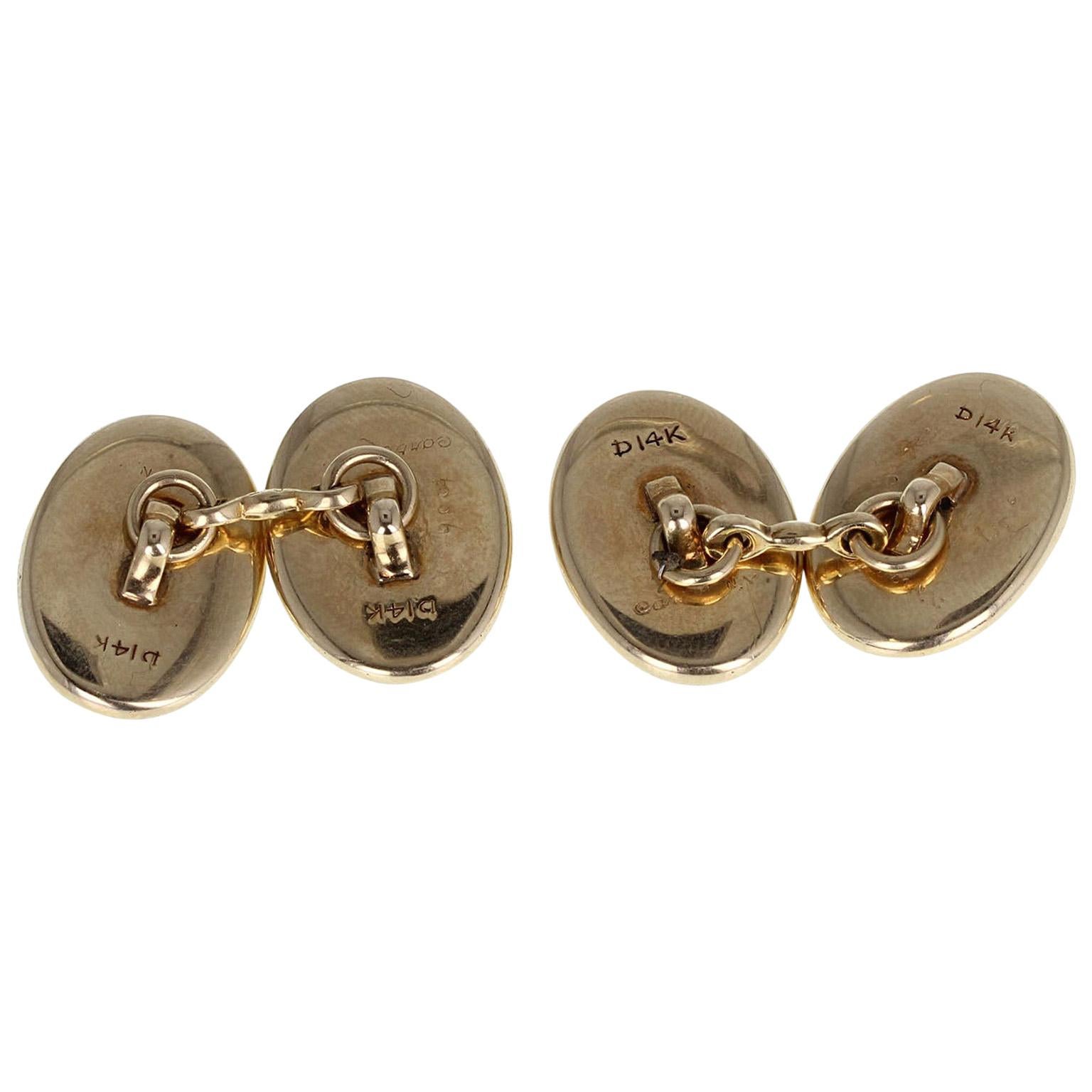  An exceptional pair of Essex crystal cufflinks from Cartier New York, complete with their original case. Each oval crystal depicting beautifully a detailed painting of a dog, set in an oval frame of 14-carat yellow gold. Joined together with 14-ct