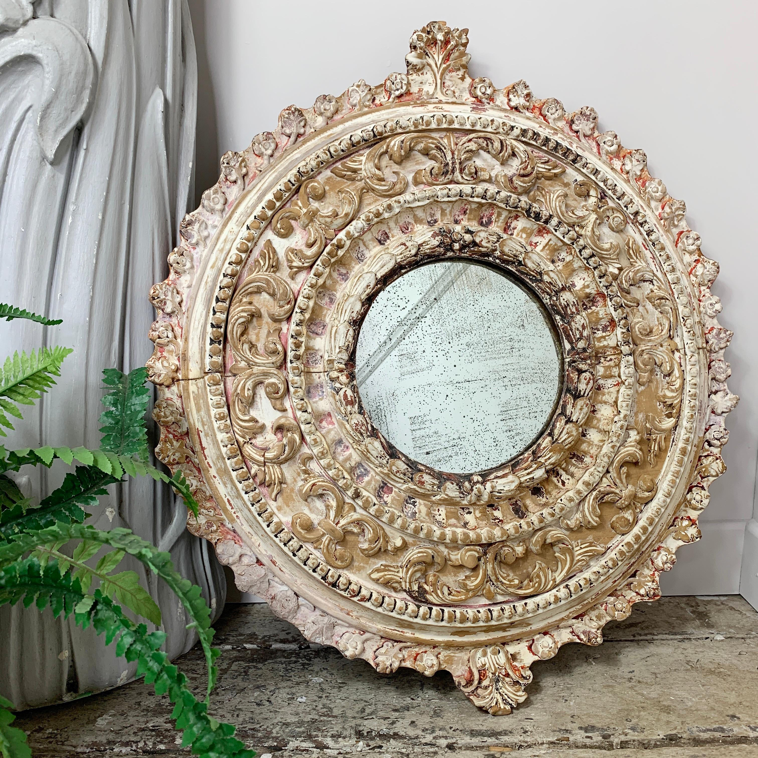 Deeply carved Italian circular wood mirror, circa 1920, in the Florentine style
The frame is profusely decorated with acanthus leaves and fauna, then overpainted
The mirror plate is well foxed, making this an exceptional and unique interiors