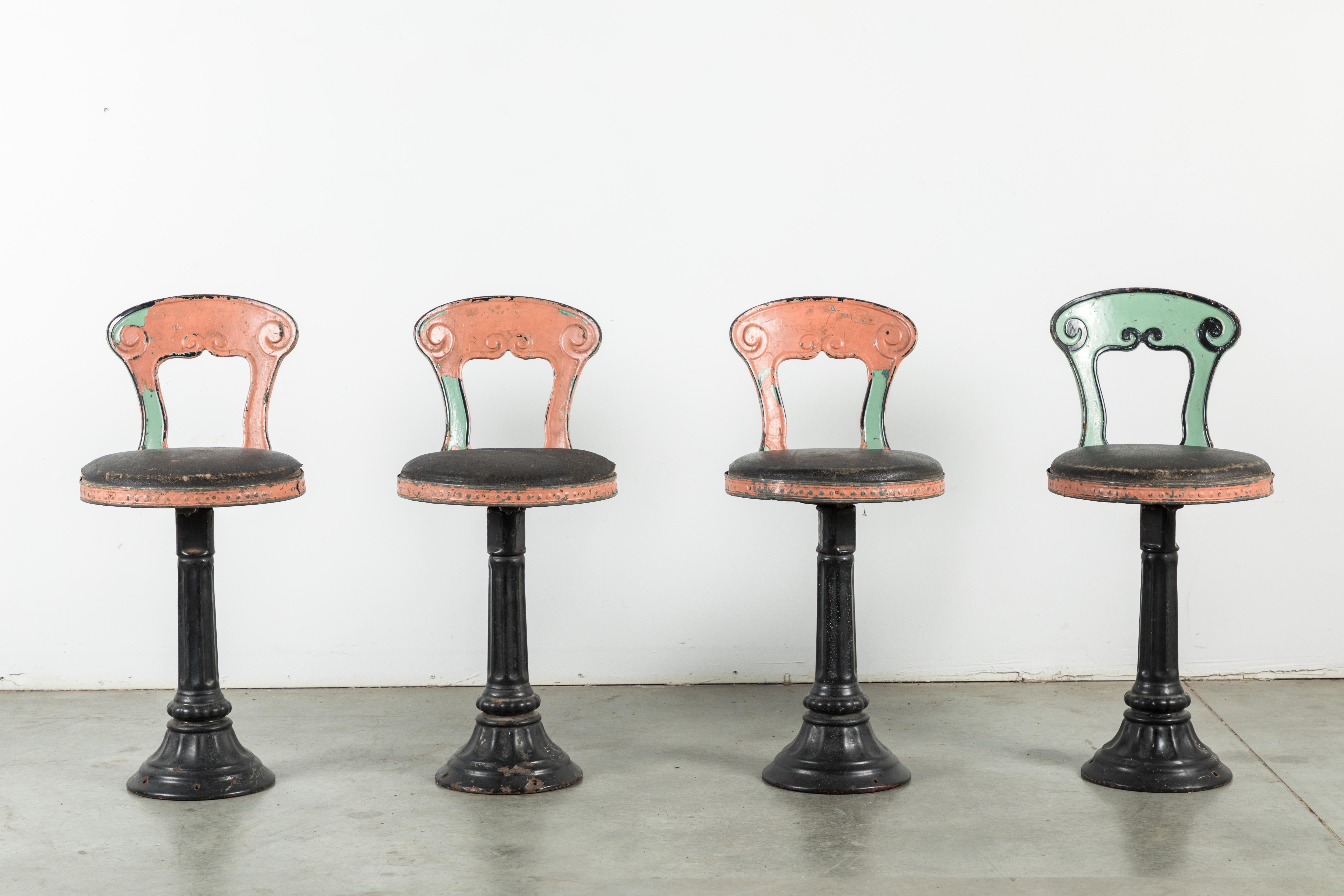 Great set of four cast iron soda fountain chairs. Found in the northeast. Original multi layer pink and green paint surface. Also original leather chair surface. Very nice cast iron bases.