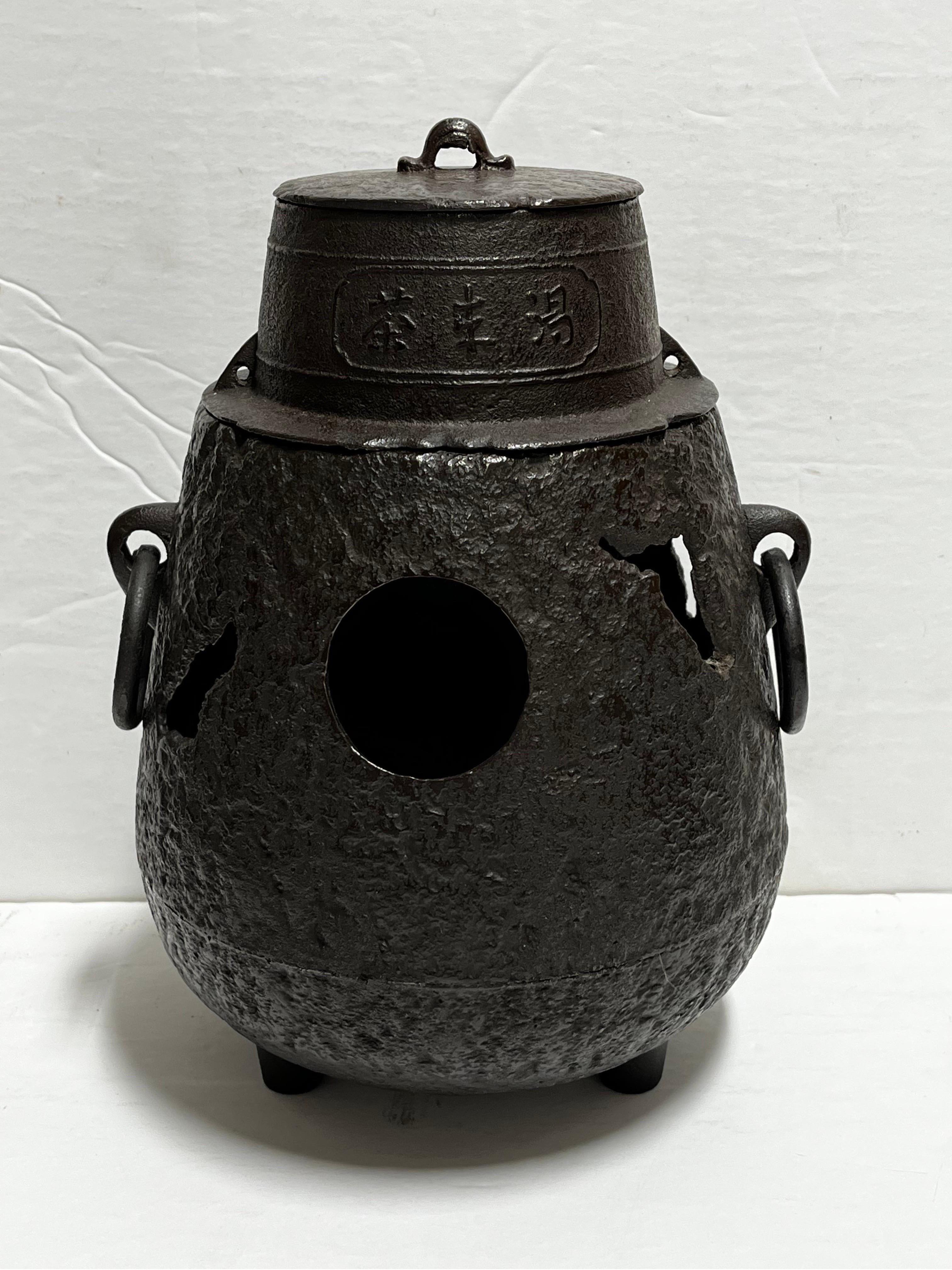 An antique Asian, probably Japanese in origin, cast iron hibachi brazier or Chagama Furo Kama. Dates to circa 1920’s. This type of object was used to heat the water for the tea ceremony. A bit about this item from wikipedia, 