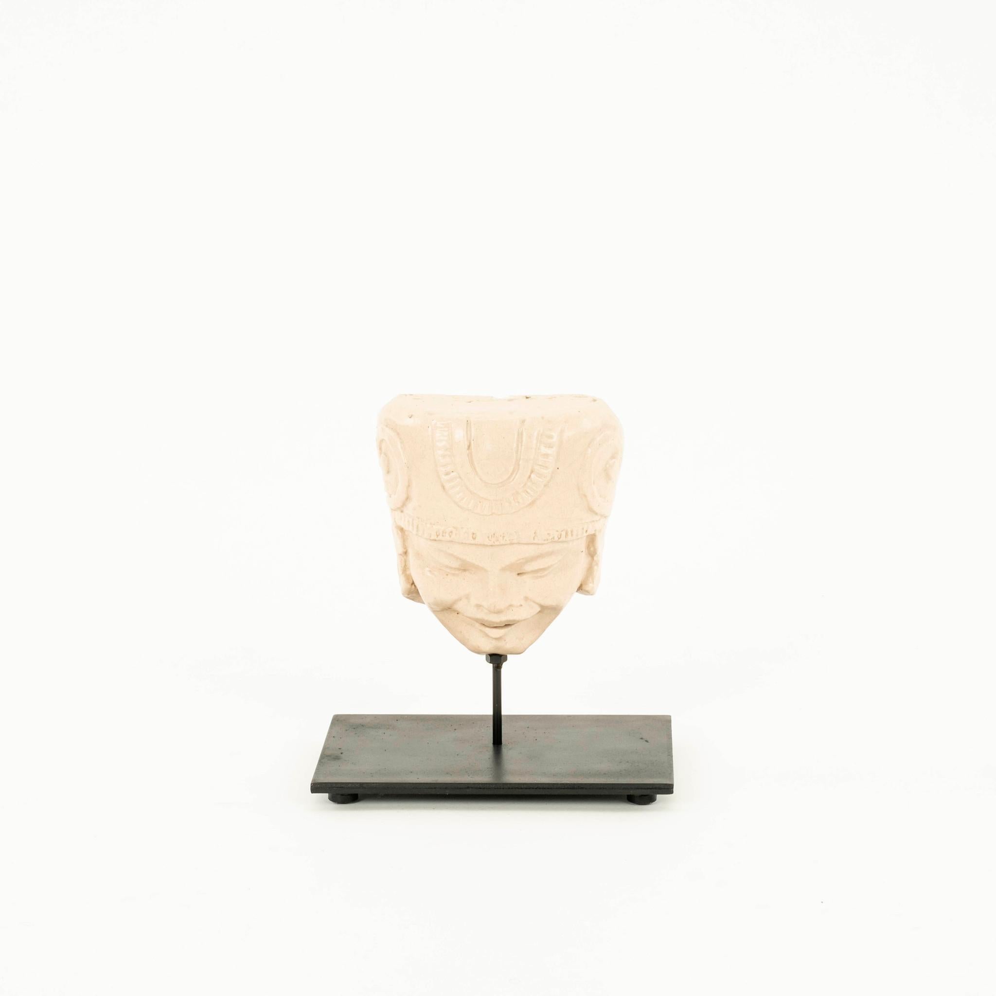 Early 20th Century figural cast clay face mask mounted on steel stand.