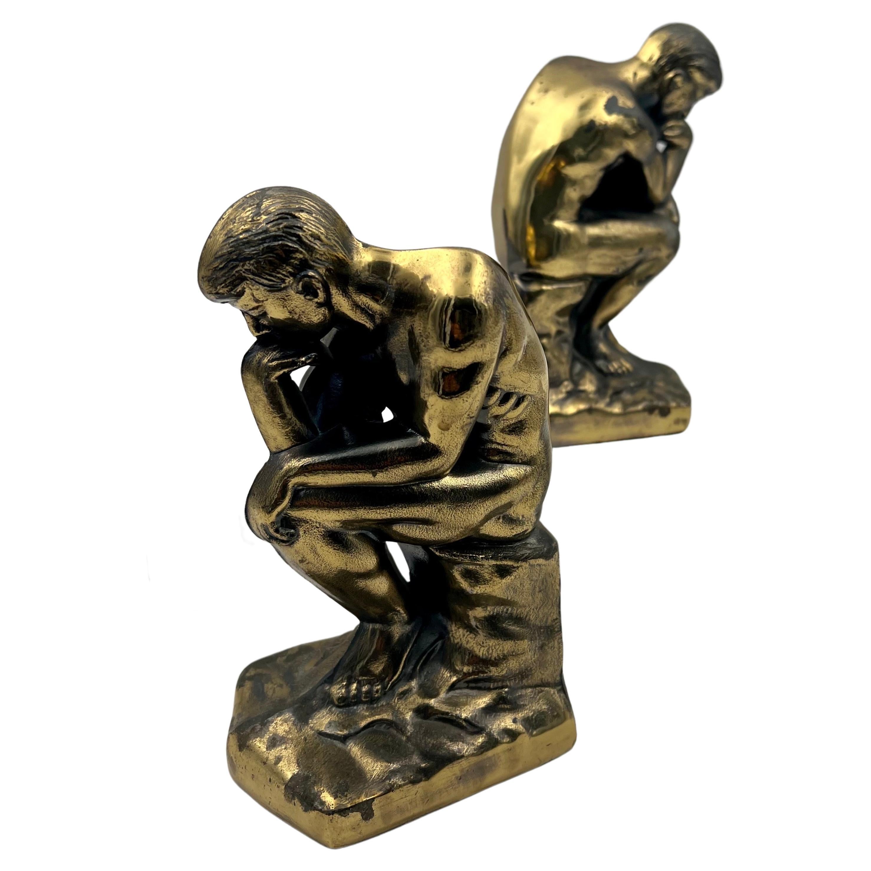 Rare pair of cast metal bookends, after Rodin The Thinker sculpture in a brass patinated finish with a copyright from 1908, a great piece of conversation after a masterpiece.
