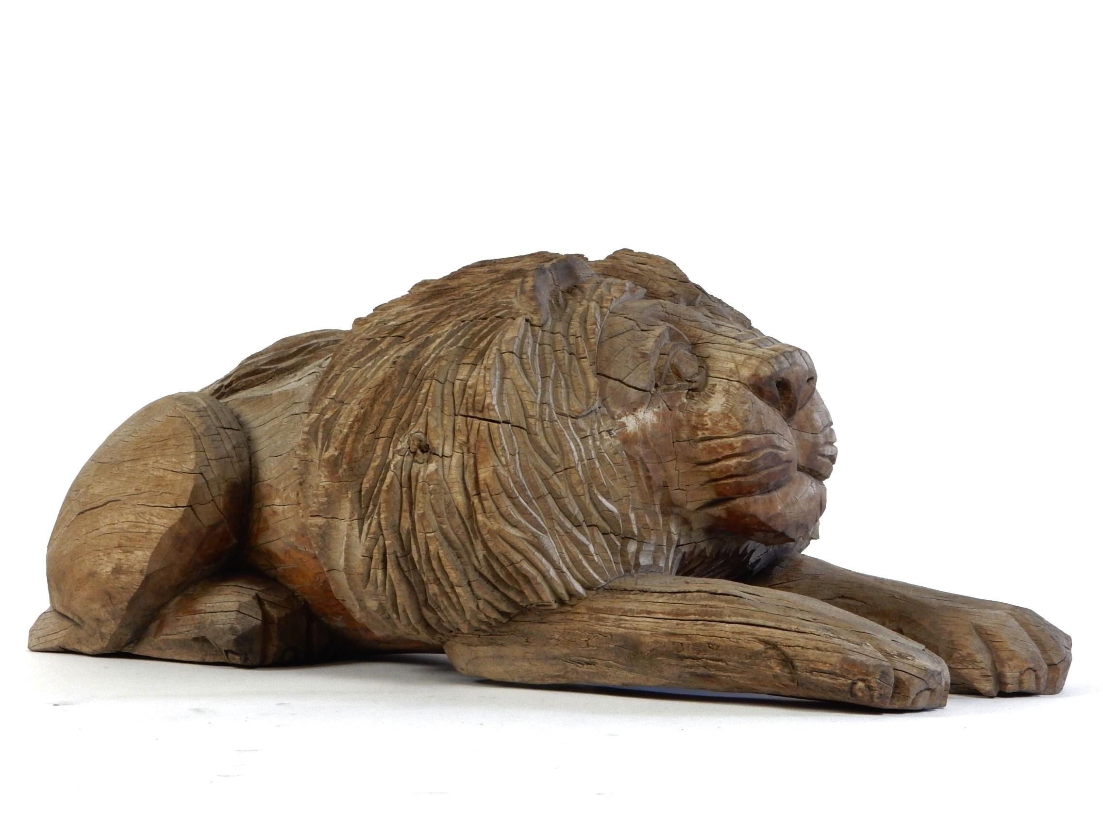 Charming early 20th century hand carved laying lion sculpture.
Formed out a single block of wood.
Fabulous piece of folk art with nice aged patina. 