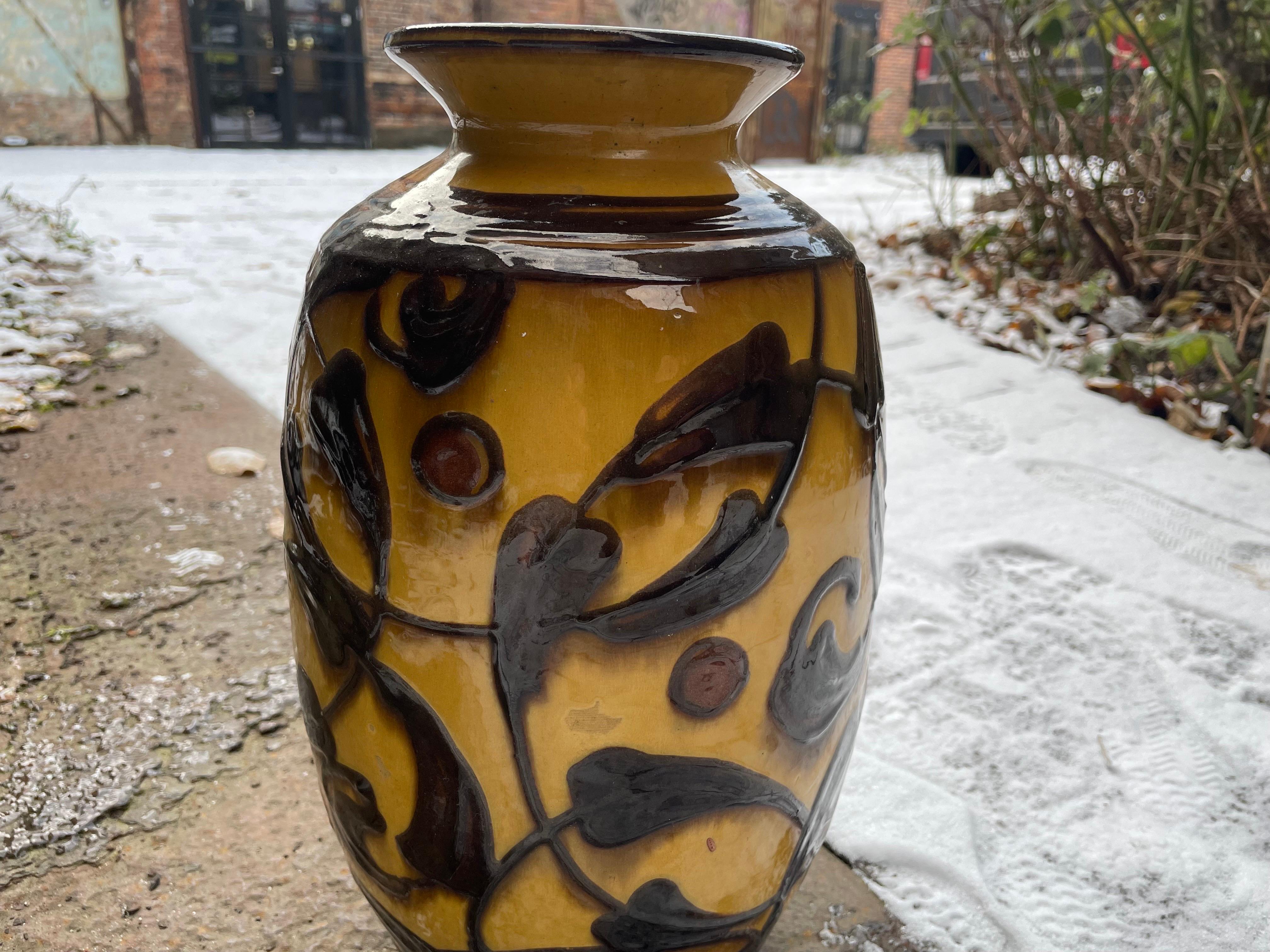 A ceramic vase with a floral motif, by Herman August Kähler with a beautiful warm yellow and brown.
The vase is signed, The slightly elevated relief with soft rounded edges creates an exiting three-dimensional experience.