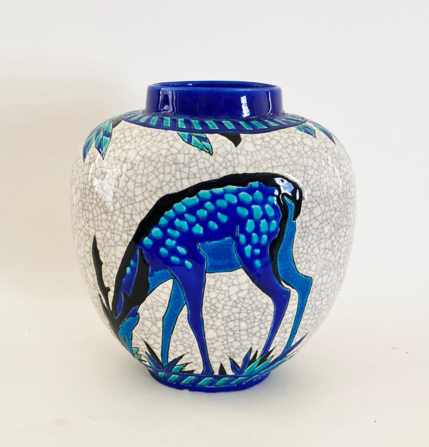 Here is a wonderful vase by Charles Catteau for Keramis, Belgium. The vase depicts a deer and foliage on both sides with a crackle glaze background. It is signed and numbered on the underside.

Condition is very good--there are no chips, cracks or