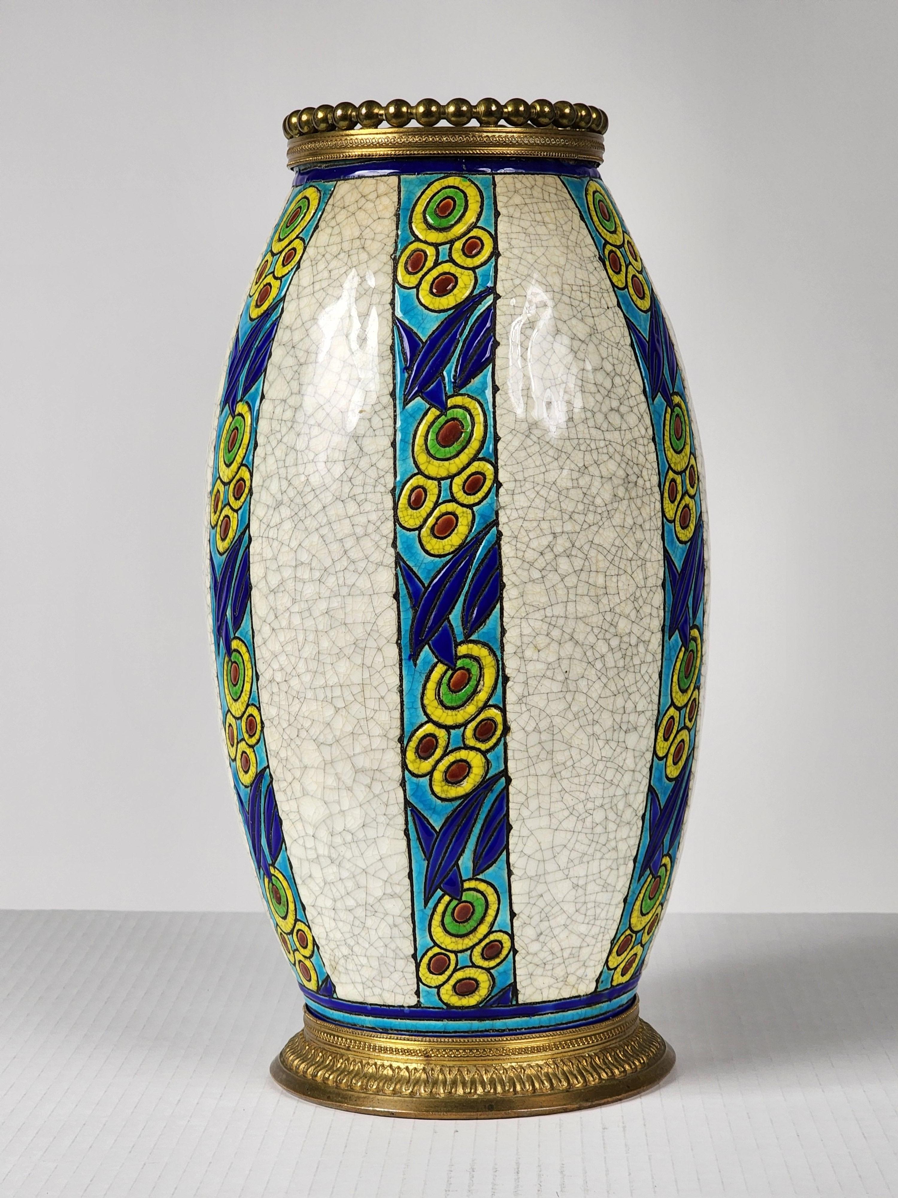 Rare  Version du vase de Charles Catteau avec une garniture en laiton massif finement détaillée. 

Fabriqué en Belgique pour Boch Frères Keramis, modèle 895 D. 947

La couronne sur le dessus mesure 4,25 pouces au point le plus large.

