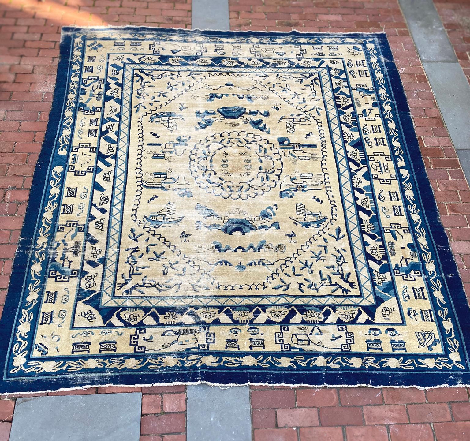 Beautifully aged Chinese Art Deco rug, woven in the 1920s. A lovely palette of blues and ivory white. The composition centers a stylized, map-like design framed by a series of borders with geometric, landscape, and floral motifs. 

Dimensions:
8'