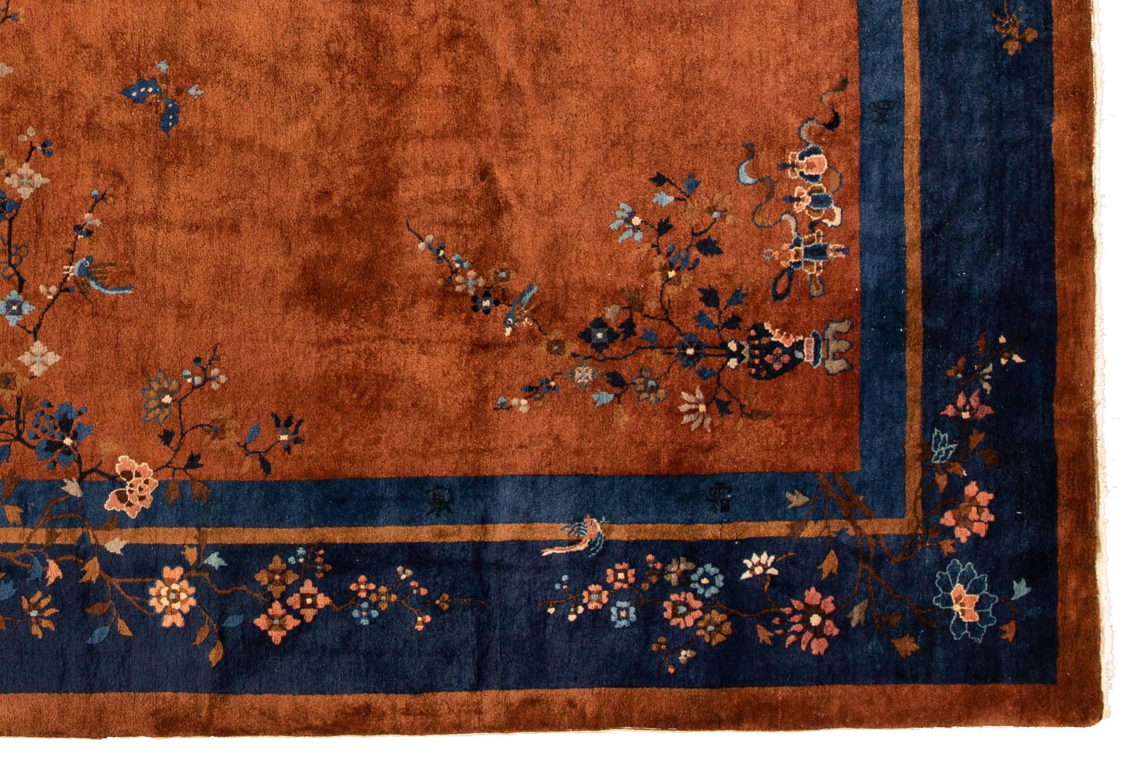 An exceptional 1920s hand-knotted Chinese Art Deco rug with a beautiful floral motif on a brown field and blue border. Measures 9.3 x 11.06.
   