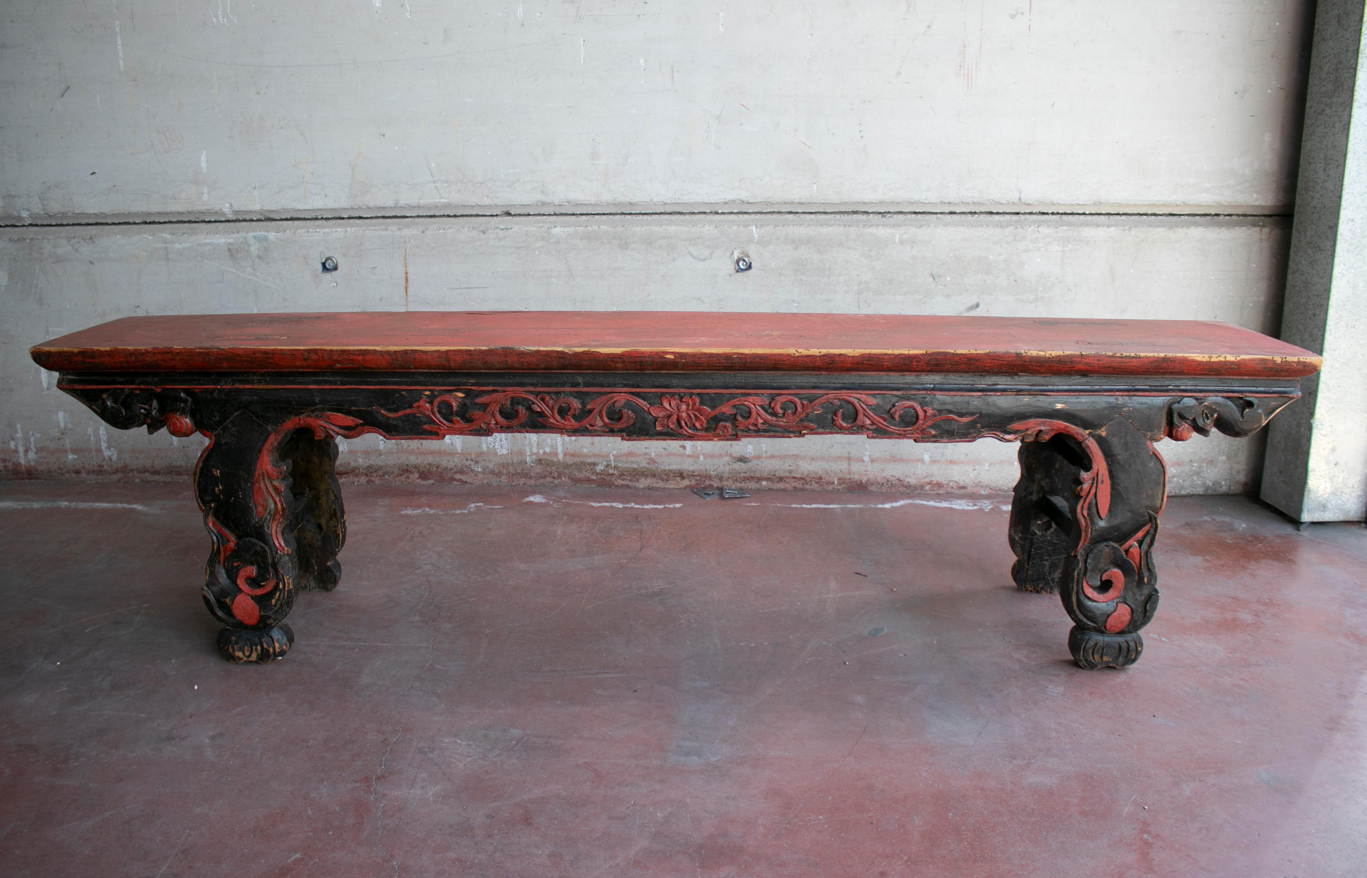 1920s Chinese black and red painted handmade wooden bench with relief carving decorations.