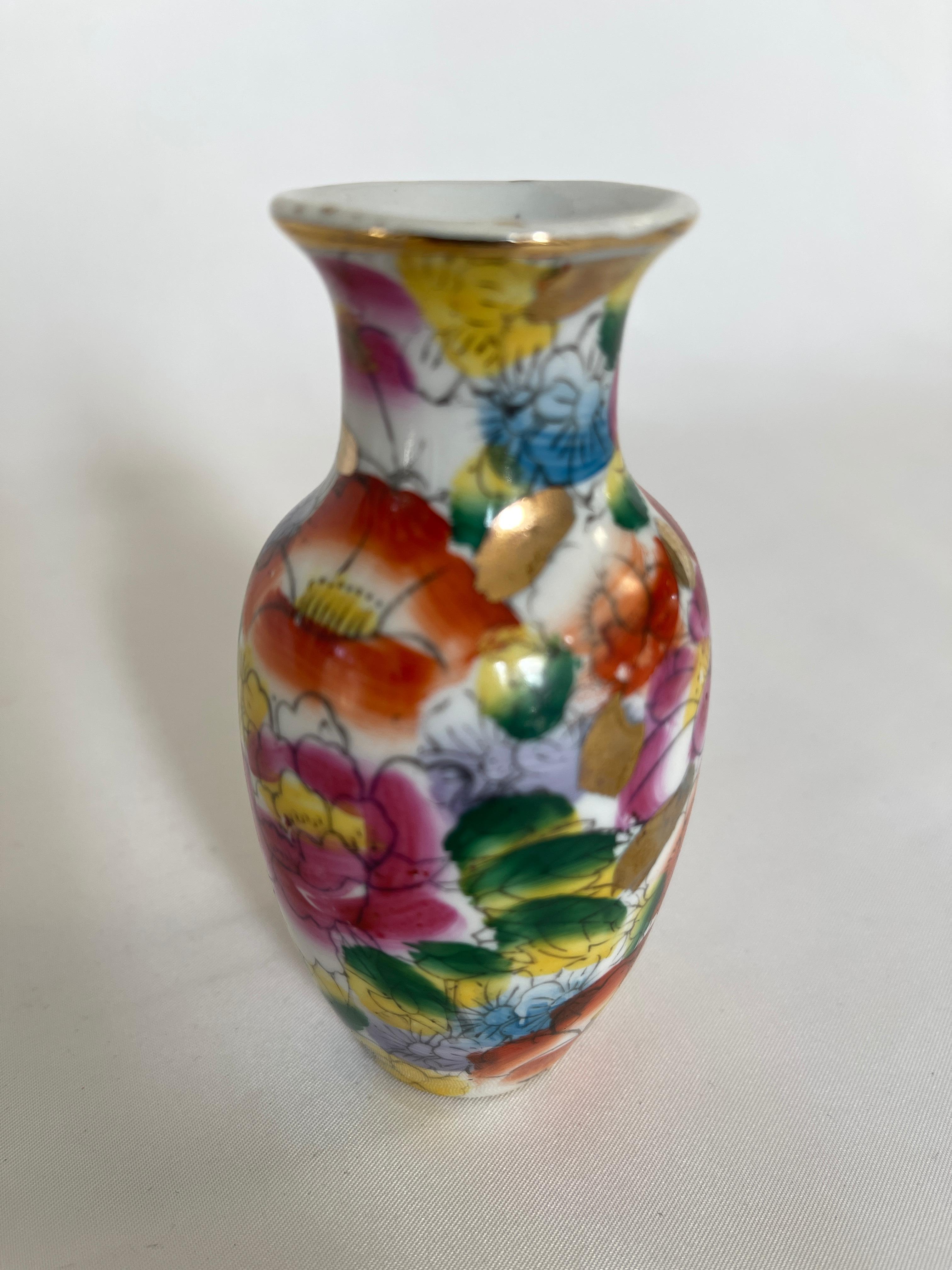 1920's Chinese export miniature ceramic vase, with hand painted floral decoration., and gilt rim. Stamped Made In China on bottom.