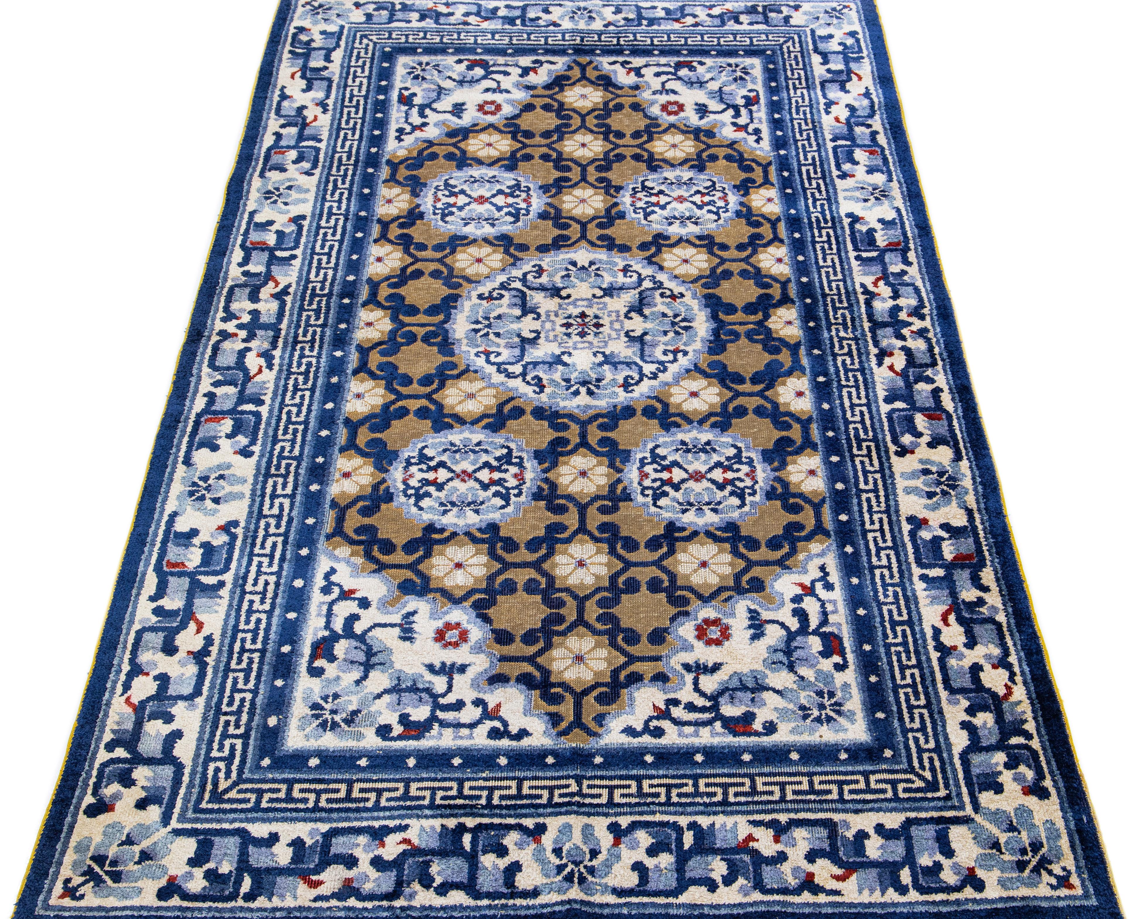 Transform the look of your home with this incredible antique Chinese Peking wool rug. This unique handmade piece is defined by its rustic brown field accompanied by cheerful blue medallion accents. Instantly bring traditional Chinese style to your