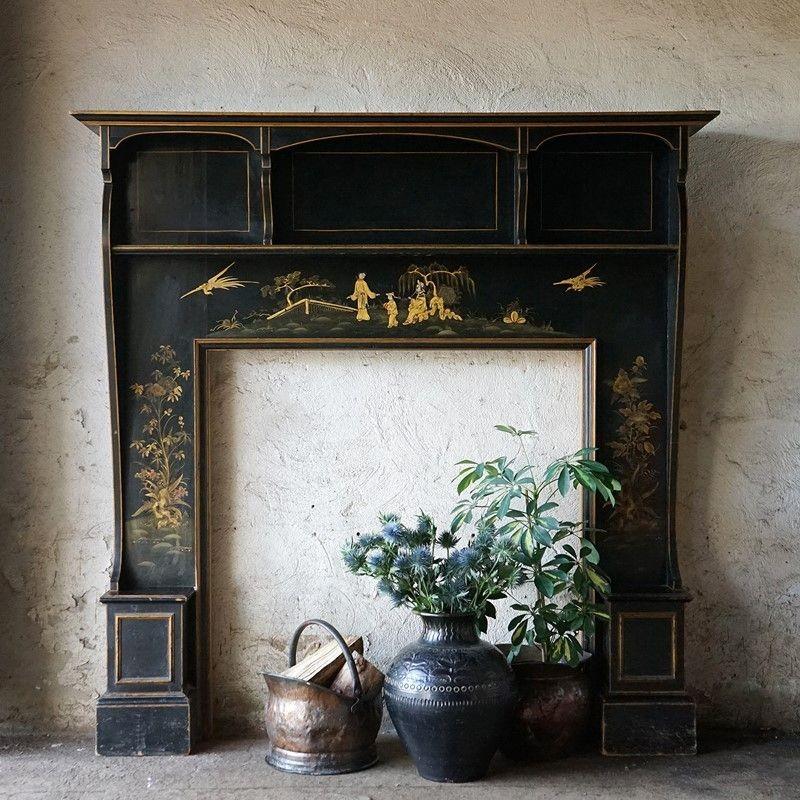 Antique Ebonised fireplace

Black lacquered wooden fire surround with gilt edging and hand-painted gilt decoration depicting figures in a naturalistic landscape with birds.

Three smaller shelves below the raised mantlepiece.

It is in very