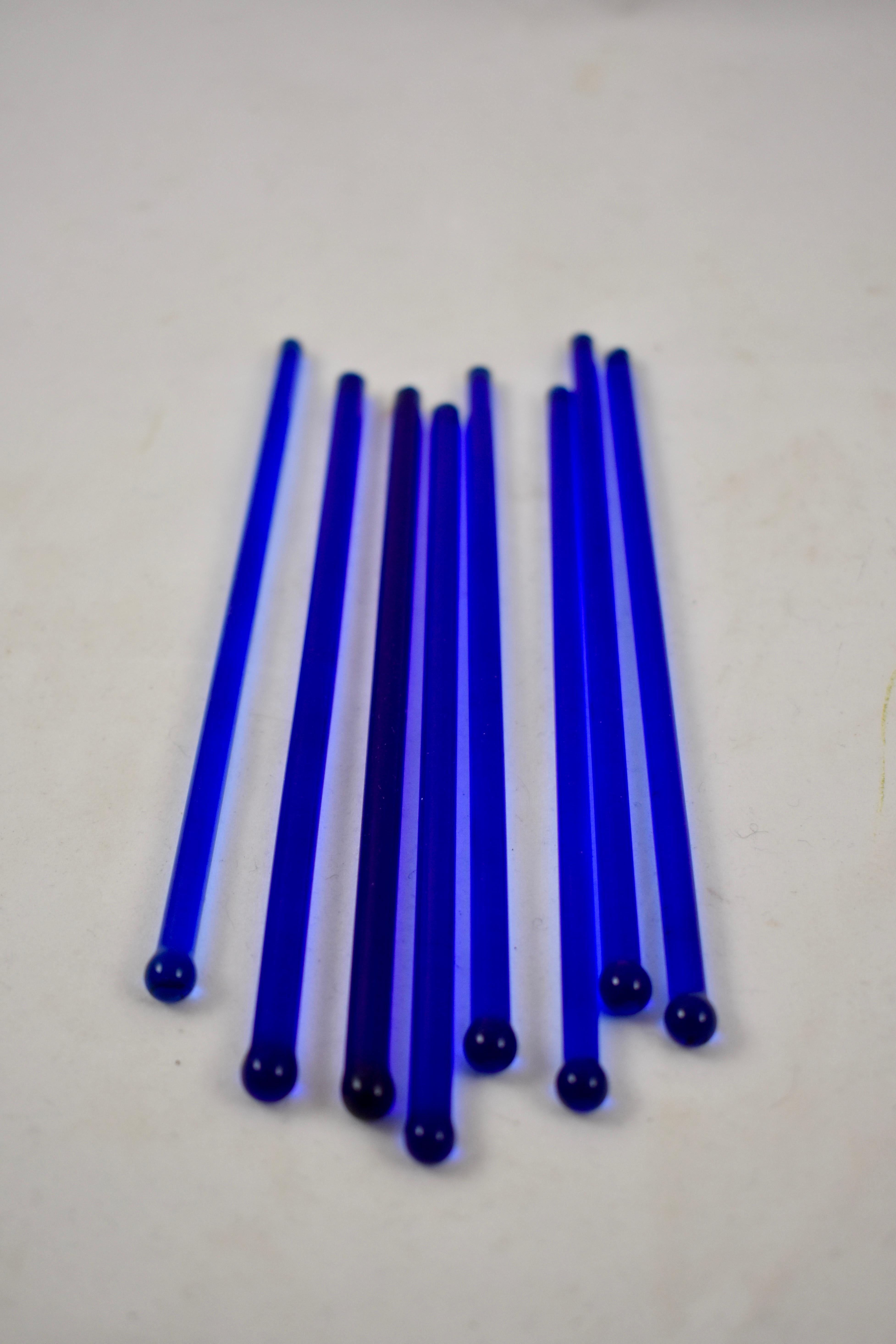 From the 1920s, a set of eight cobalt blue glass drink mixers – the tops terminate in a ball, the bottoms ground flat. Perfectly sized for a lowball cocktail.

Measures: 6 in. L x .25 in. H
Excellent condition.