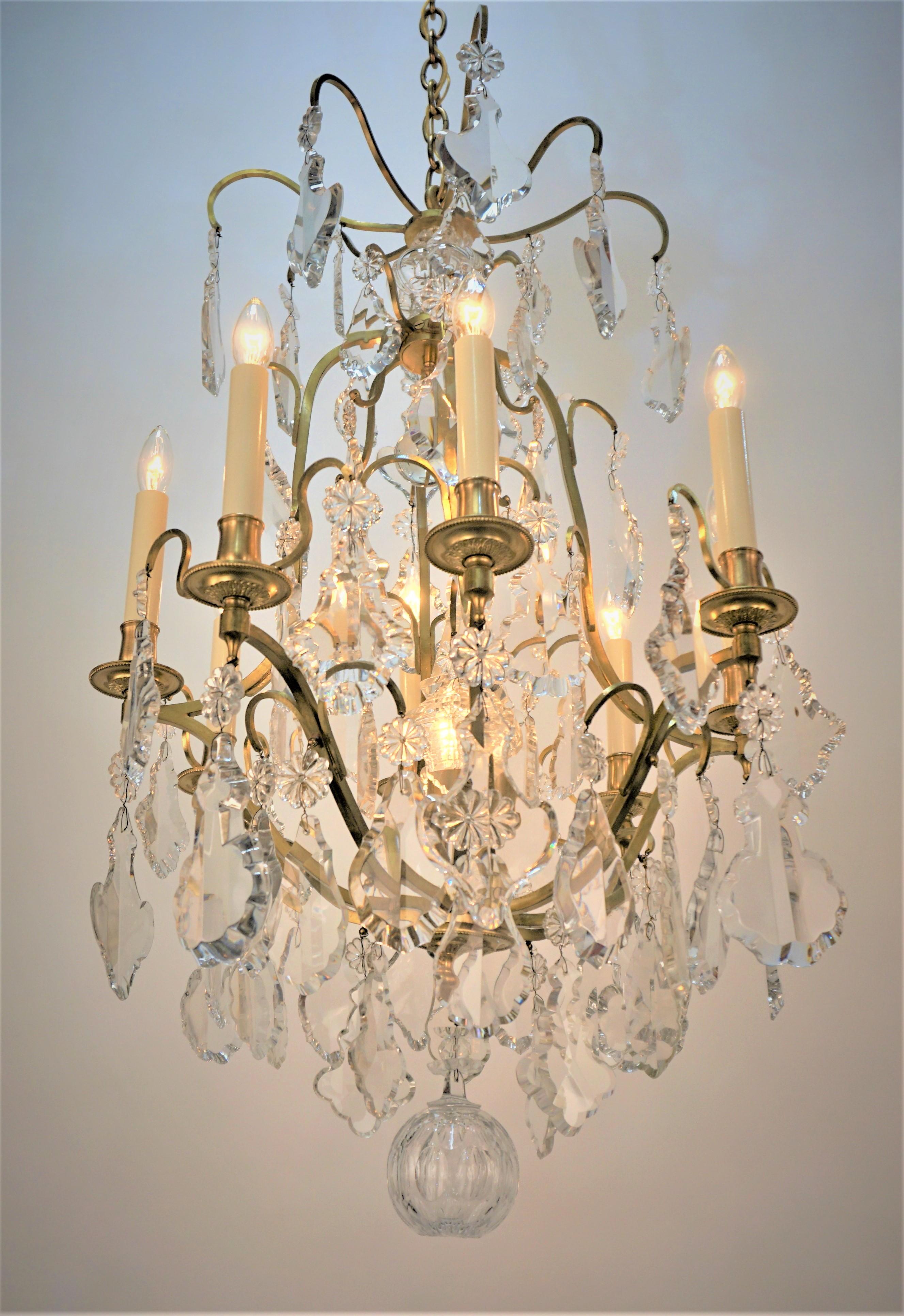 Elegant crystal bronze chandelier with eight arm candles and center light within center crystal.
