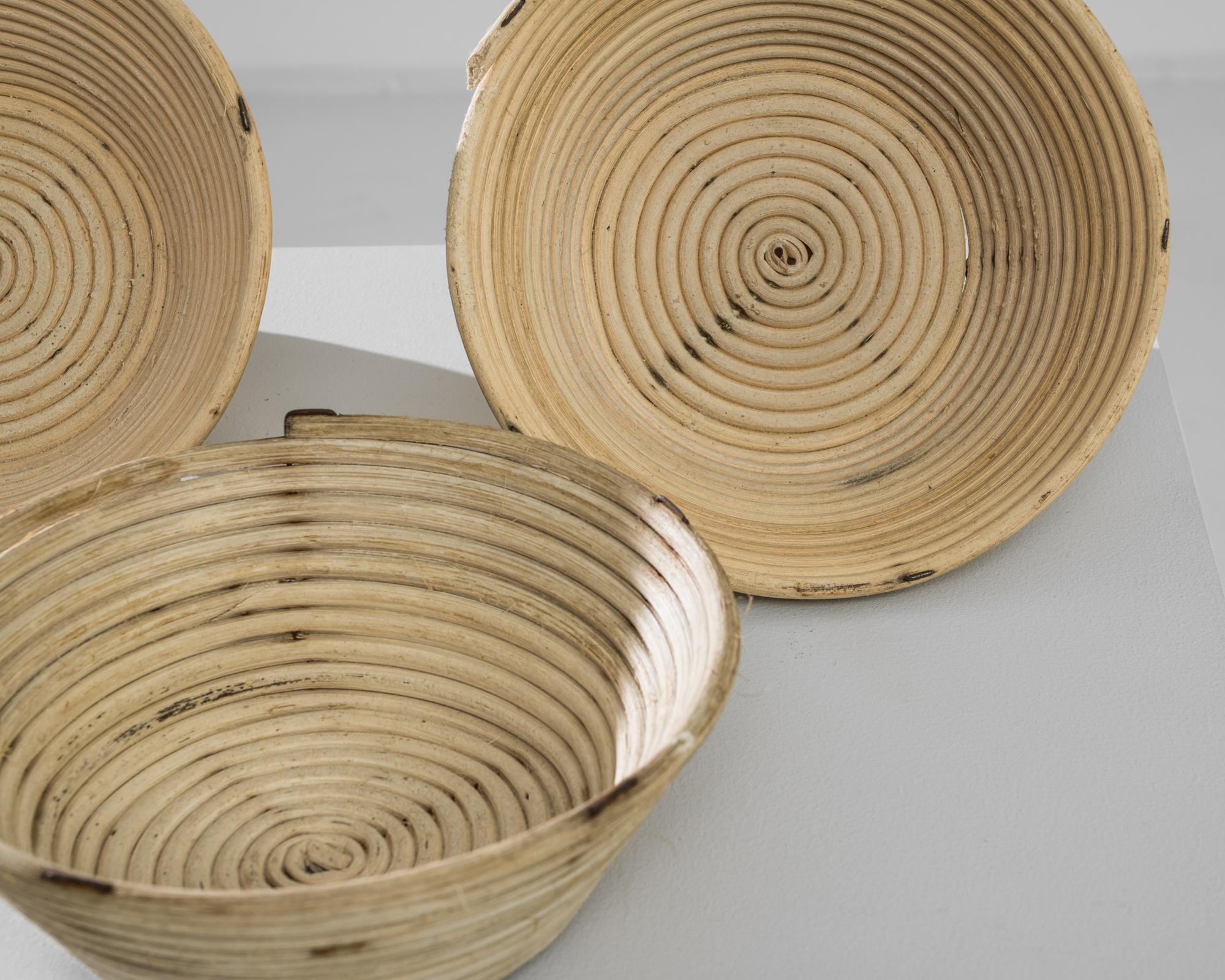 This 1920s Czech wicker basket exudes vintage charm and practicality, perfect for adding a rustic touch to your home decor. Crafted from natural wicker, each basket features a distinctive spiral design, showcasing the skilled craftsmanship of the