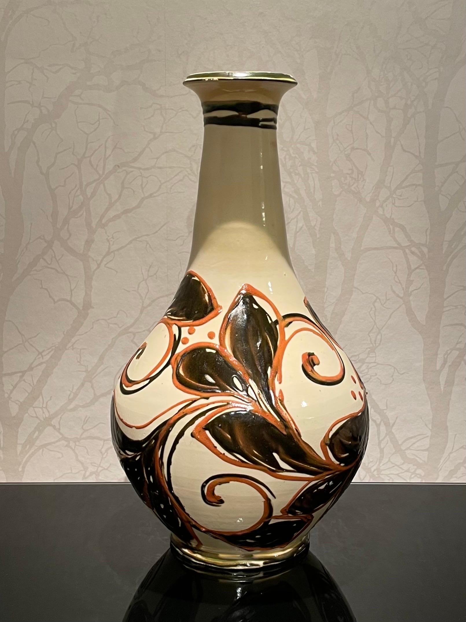 This is the 1920s Danish 46 cm tall ceramic floor vase by Herman Kähler.

It comes with a globular body with tall tapering neck, high glossy surface and a clear red and very deep blue, nearly black color, on a bright cream white base.
The vase has a