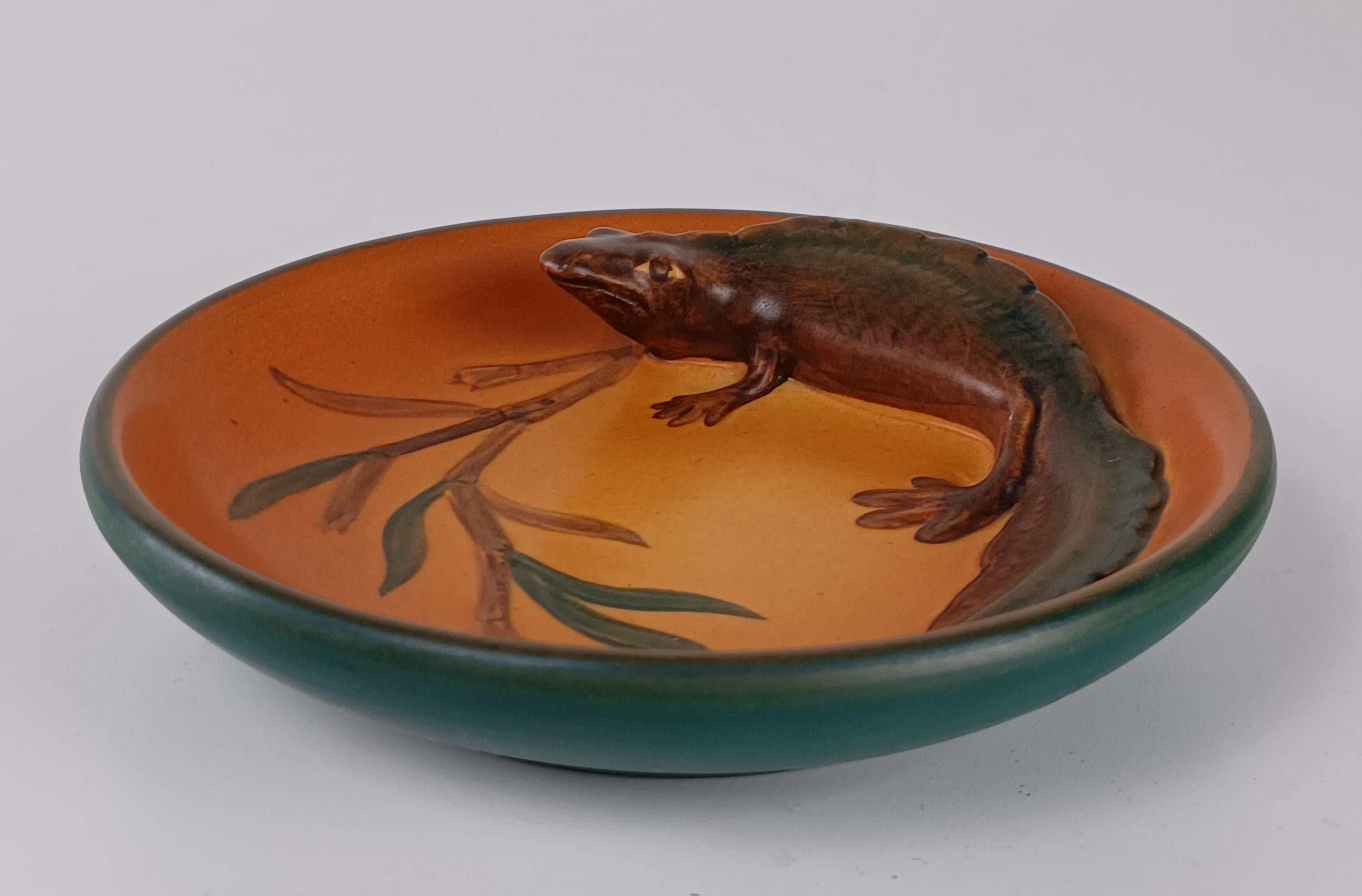 1920's Danish Art Nouveau Handcrafted Fish and Salamander Bowls by P. Ipsens Enke

The handcrafted art nuveau bowls were created featuring a salamander and two fish were designed in 1929 by Axel Sørensen as ash tray and cigarette bowls are is in