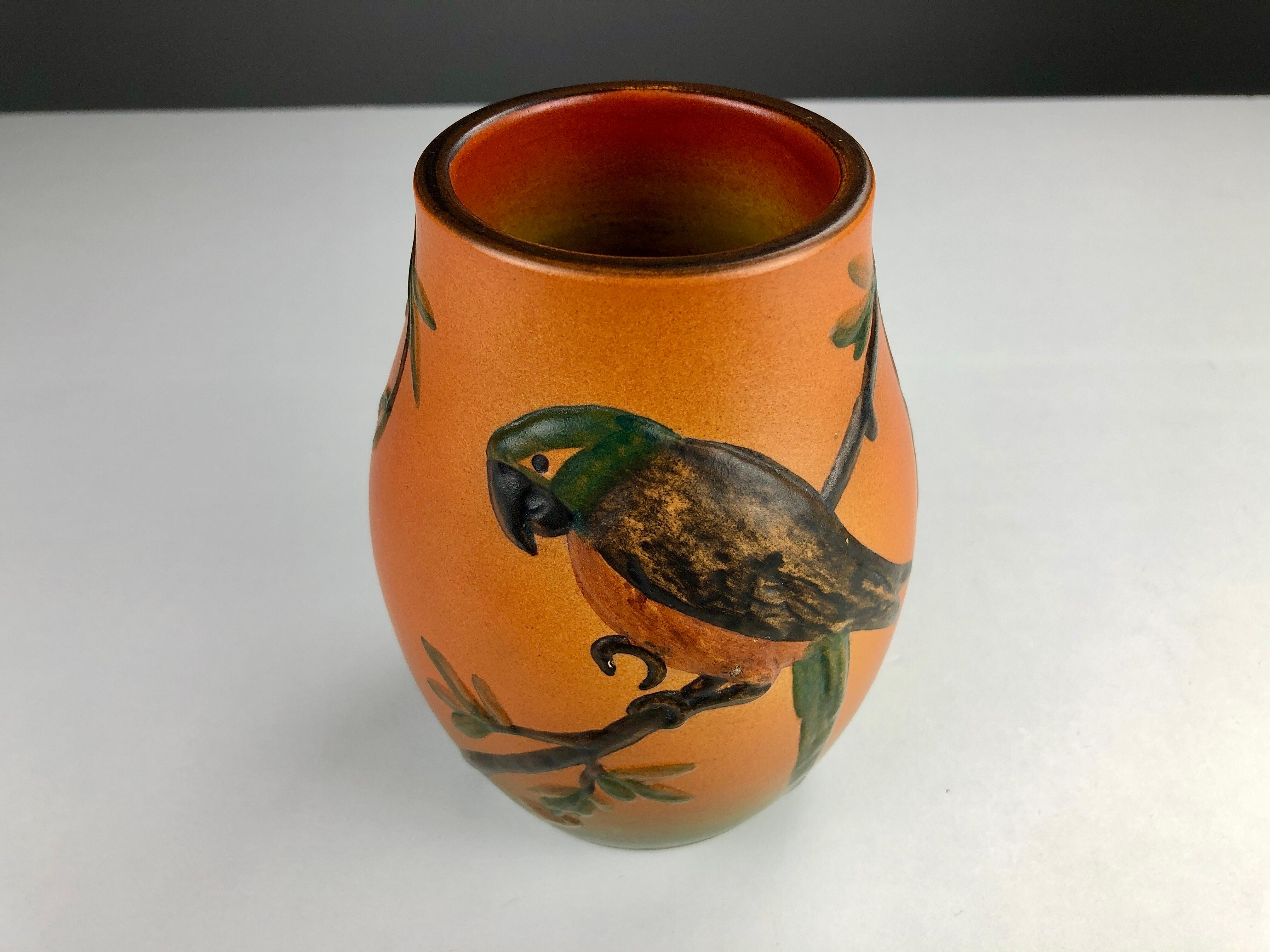 Hand-crafted Danish Art Nouveau flower decorated vase by West in 1927 for P. Ipsens Enke

The art nouveau vase feature very well made lively parrot with branches and leafs is in very good condition.

P. Ipsens Enke (1843 - 1955) was a very