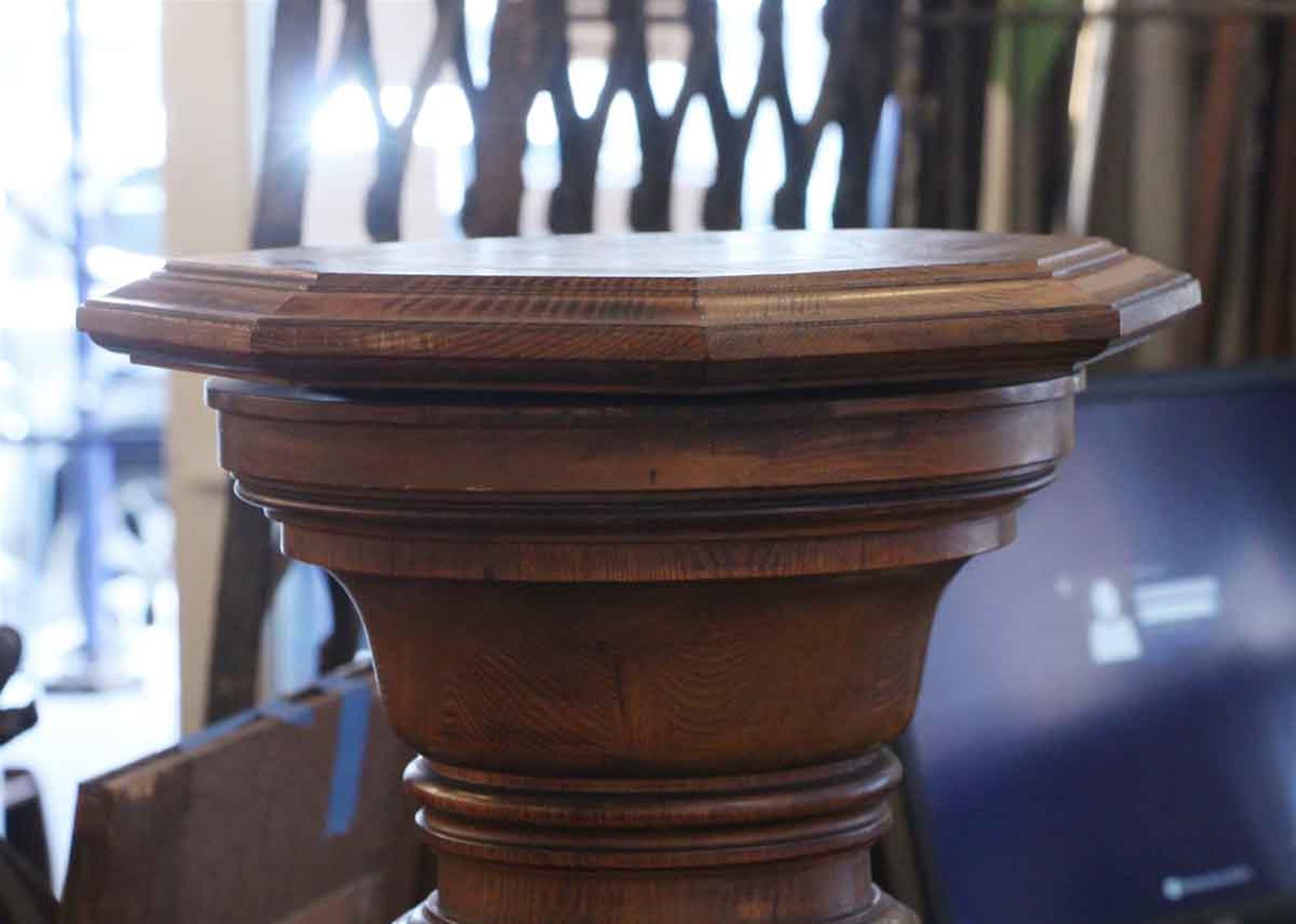 Dark wood tone oak pedestal with an octagonal pivoting and removable top from the 1920s. This can be seen at our 2420 Broadway location on the upper west side in Manhattan.