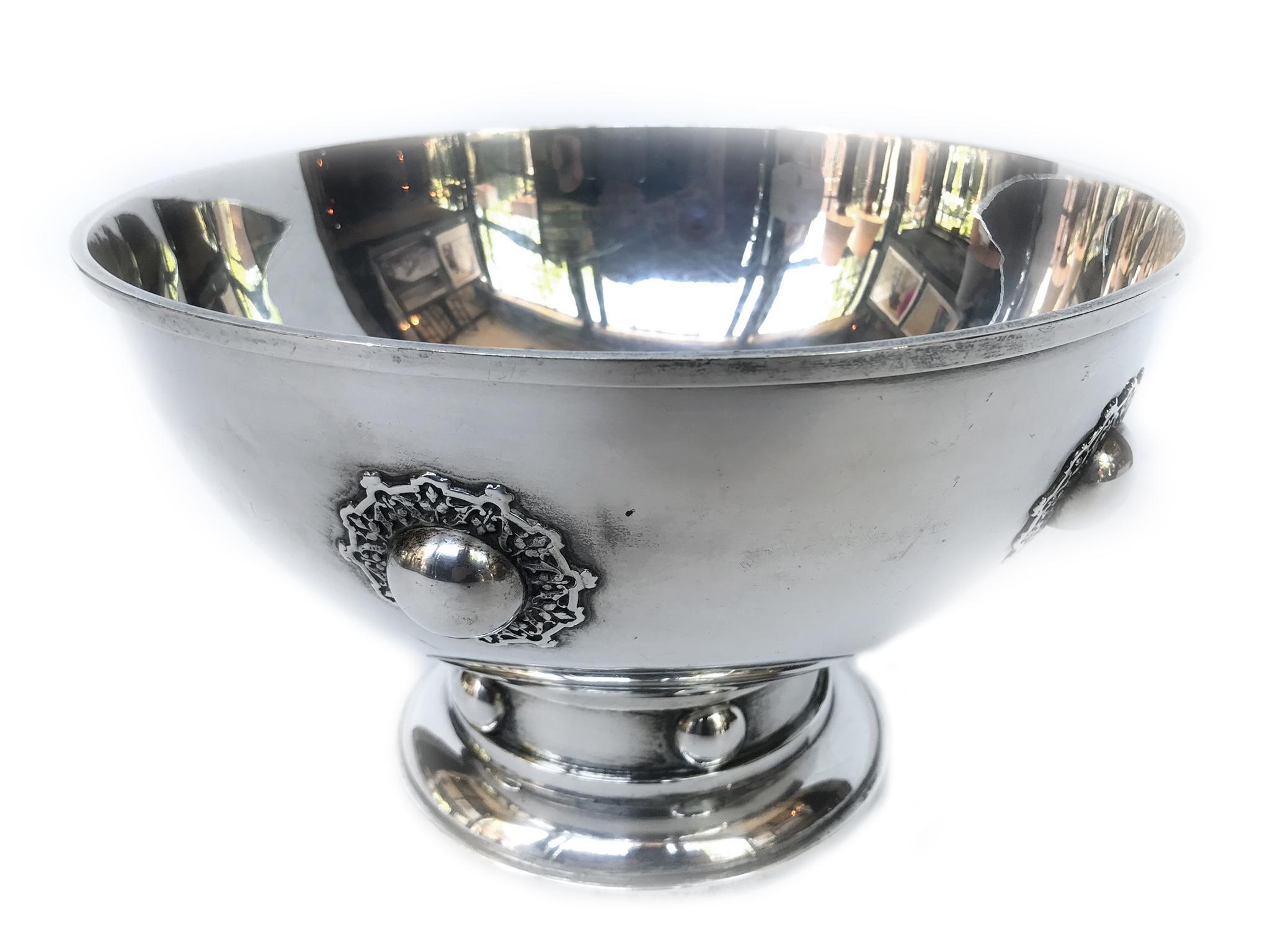 1920s sterling silver bowl designed by O.R. Dunn for Hawkes Sterling. Its elegant design features medallion studs with floral haloes.

Dimensions:
9 in. diameter
5.5 in height.