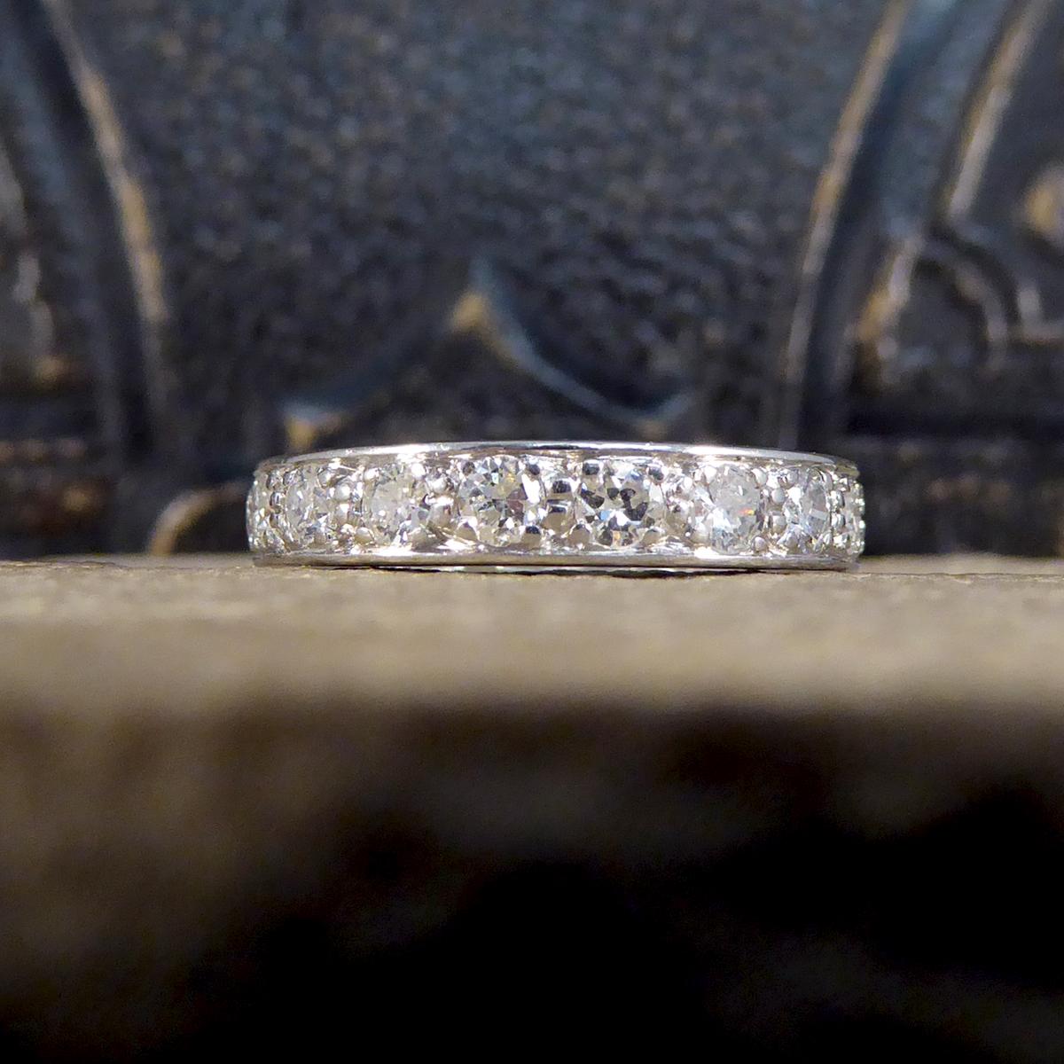 Such a lovely and classic 1920's full eternity ring. This ring has been hand crafted in 18ct White Gold and set with 18 Brilliant Cut Diamonds weighing a total of 1.44ct and sparkling all across the head of the finger. Shows signs on the side of the