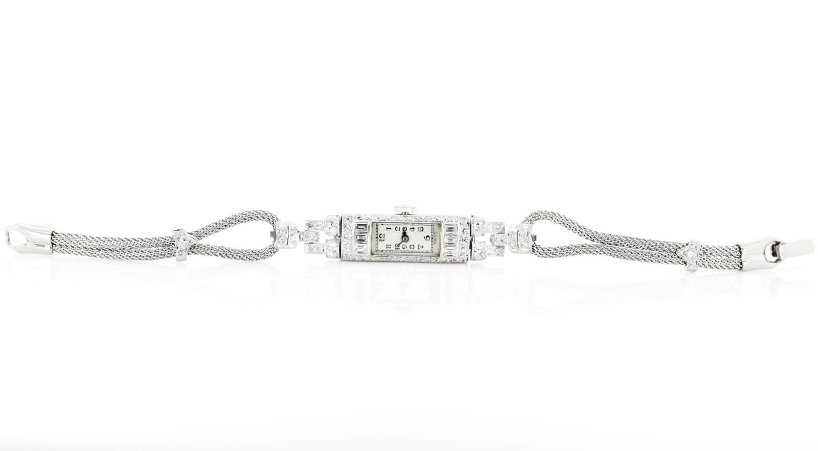 A refined Swiss made Diamond lady's watch.  Created in platinum and set with a medley of old Single and Baguette cut Diamonds, all weighing an approx.  1.40 carat of G/I color - VS clarity.   A mesh rope like band completes this 6 inches long circa