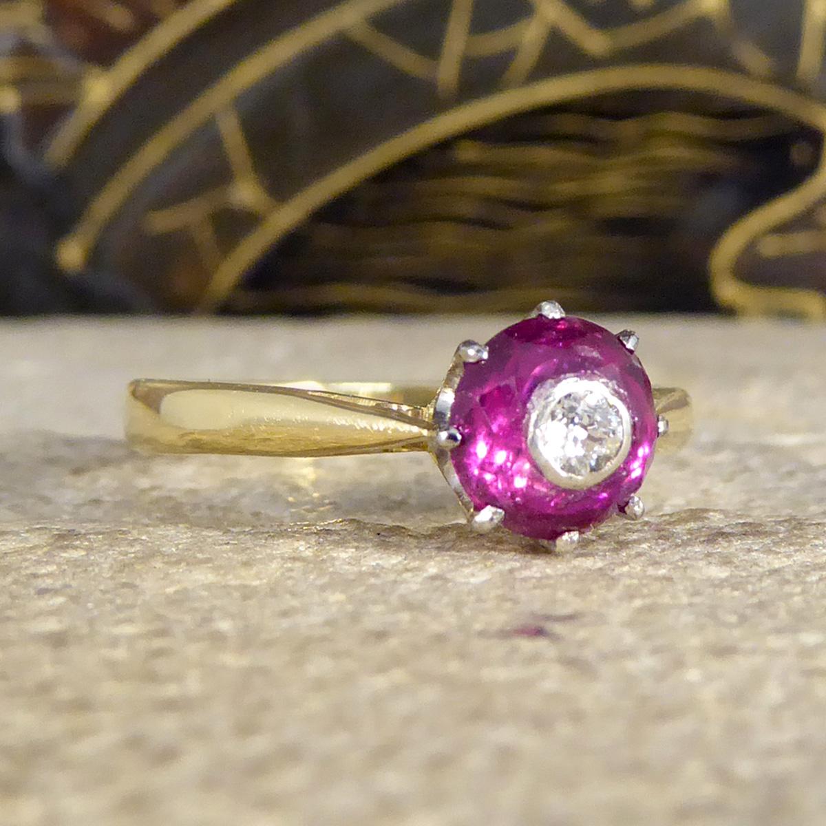 This lovely ring was crafted in the 1920's and features a beautifully coloured pink/red paste stone which resembles a Ruby set with an Old European Cut Diamond in the centre giving the aesthetic of an eye, such an unusual and intriguing style