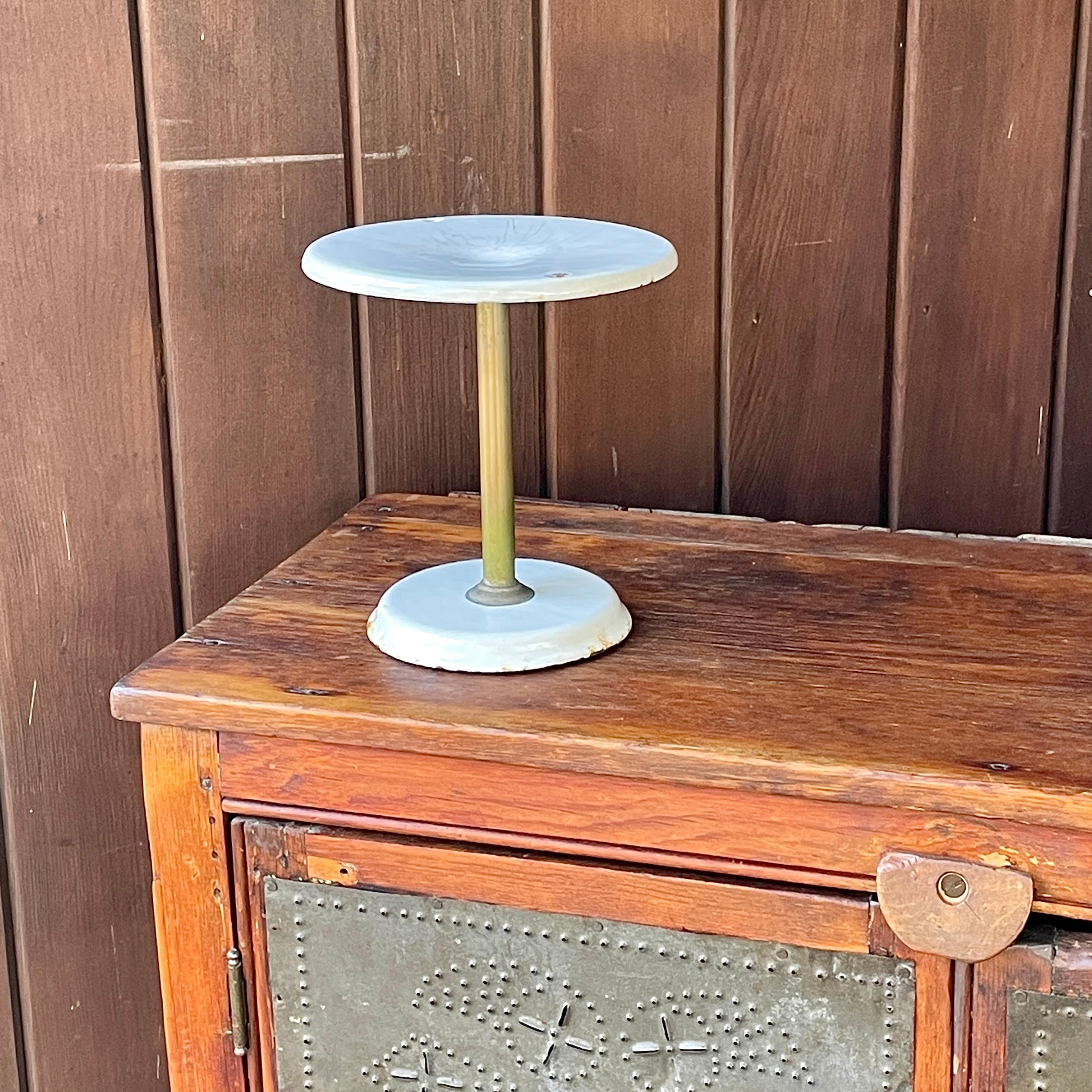 Great for displays. A piece from an Early 20th Century American Diner. Small raised display or holder of some kind. No looseness or flaking.  Two original holes in top surface, missing handle? Heavily worn, with cracks to enameled surface, wear to