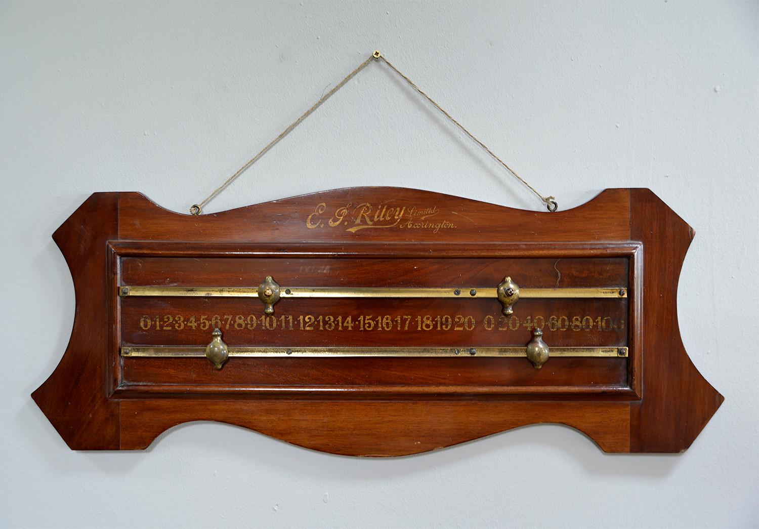 A lovely shaped mahogany billiard scoreboard in original condition with gold numbering and gold painted name “E J Riley Ltd Accrington” with brass slides and pointers. The transfer numbers are 0 to 20 and 0 to 100. 

During the 1890's E.J. Riley