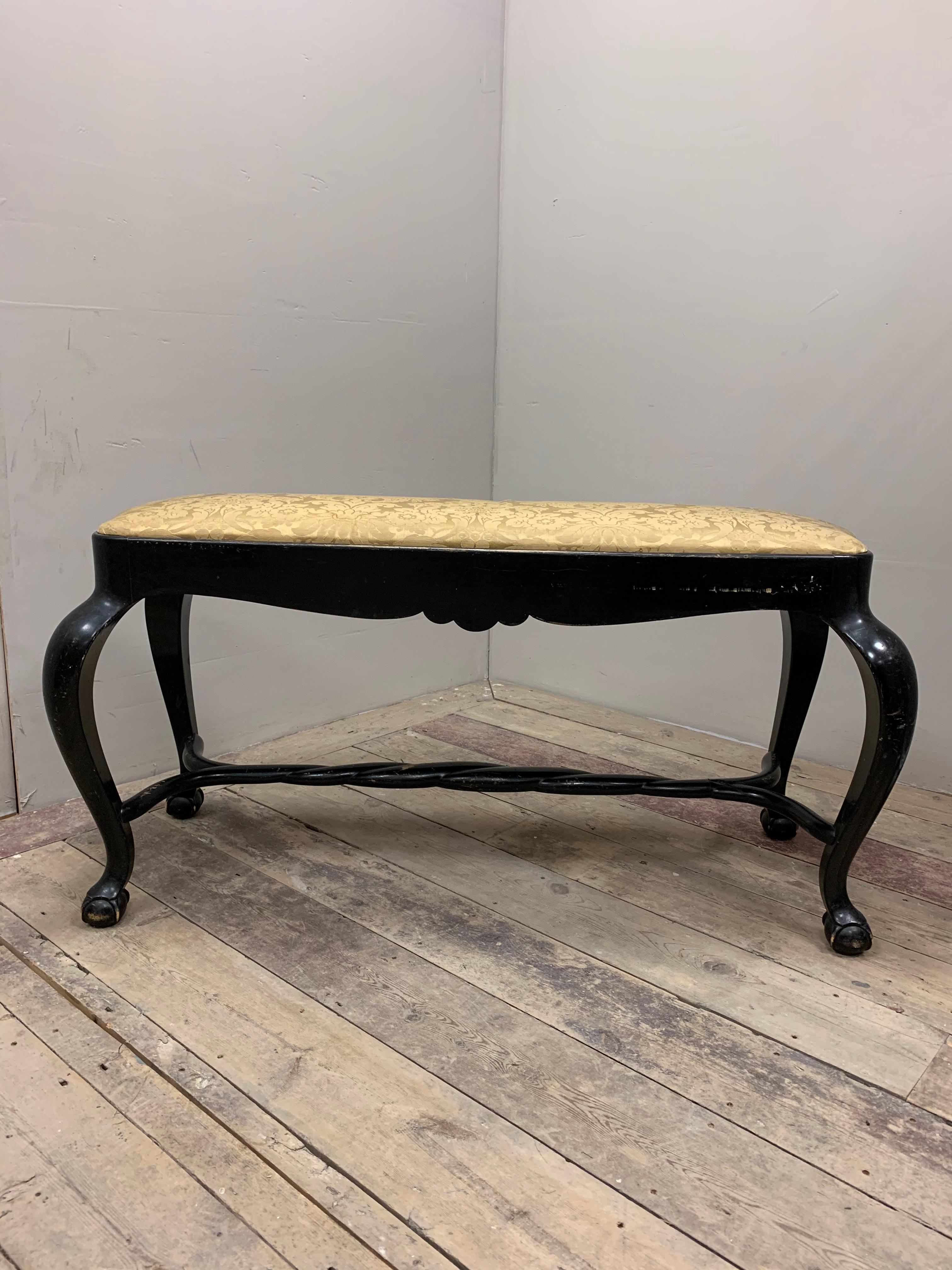Wonderful and stylish 1920s ebonised stool/bench in the Baroque style.
With a drop in seat which requires upholstering if you wish. This piece has an interesting plaited stretcher, cabriole legs and ball & claw feet.

Good for the end of a bed or