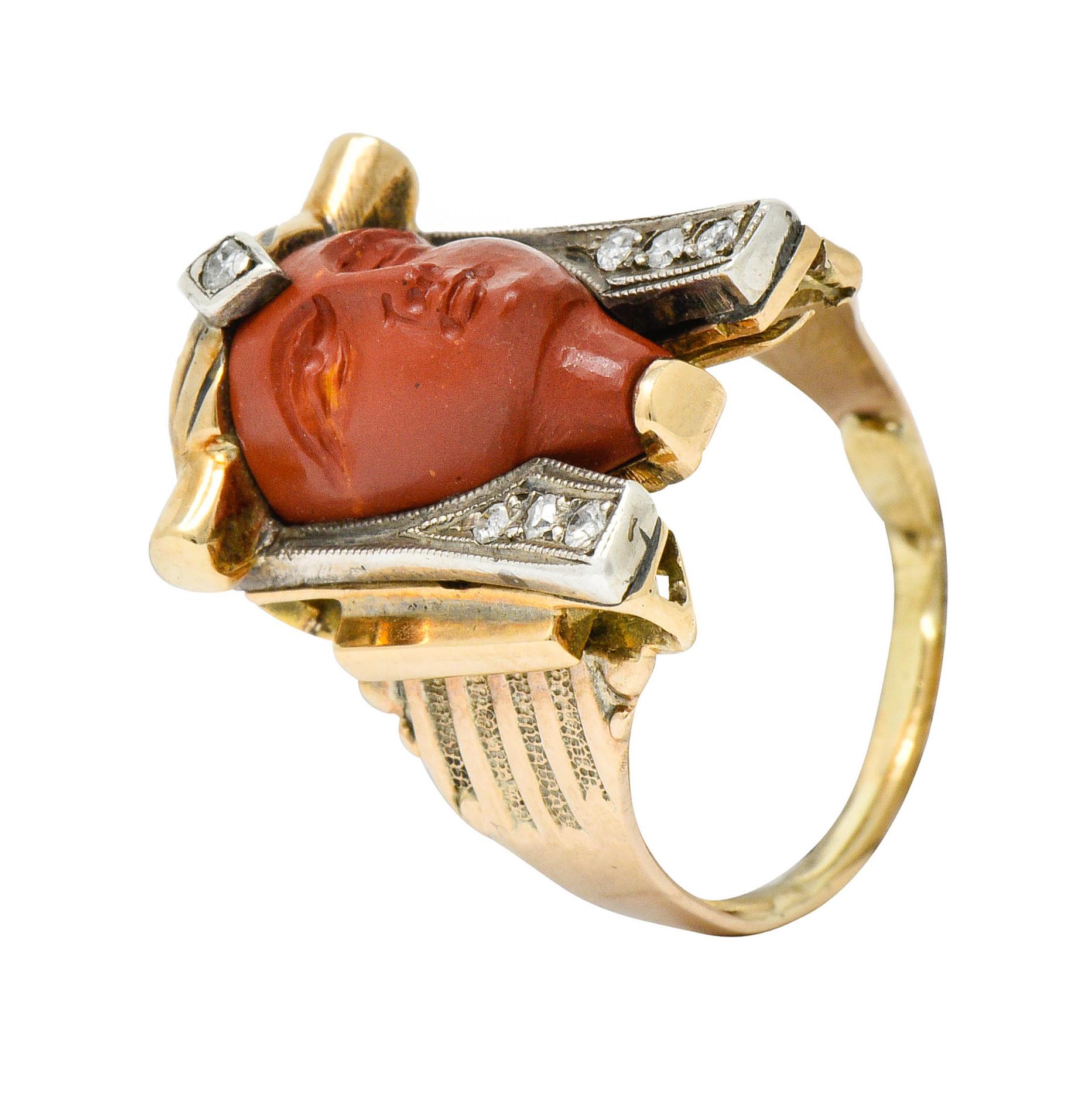 Revival ring is designed as a stylized Pharaoh with deeply ridged shoulders

Face is deeply carved jasper with brick red color and resinous luster

Headdress is accented by single cut diamonds weighing in total approximately 0.10 carat; quality