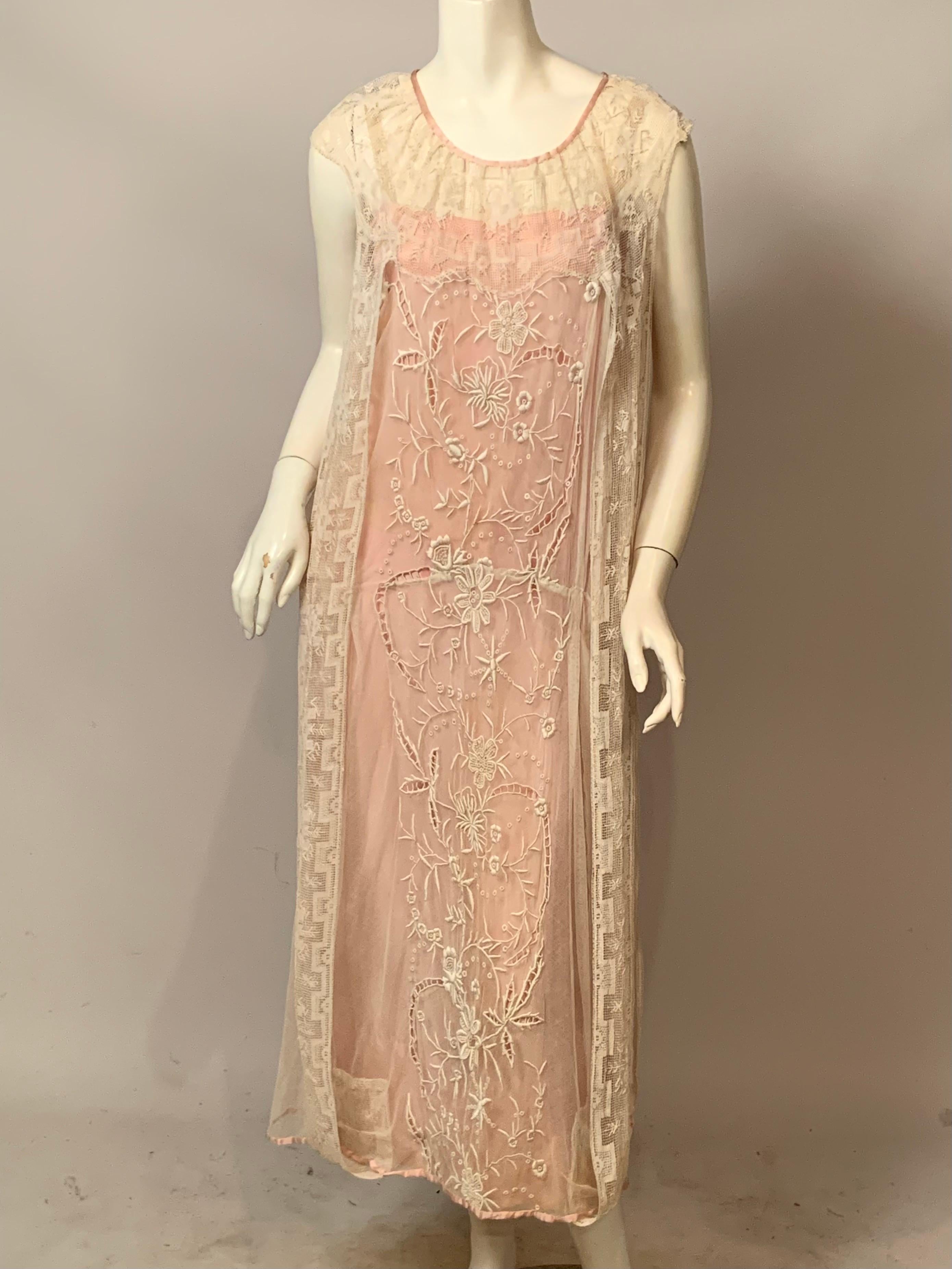 This 1920's embroidered tulle and filet lace dress is one of the nicest I have ever offered for sale.  The dress is complete with a pink silk charmeuse slip and sash, with matching trim at the neckline and hem.  The center front and back panels have