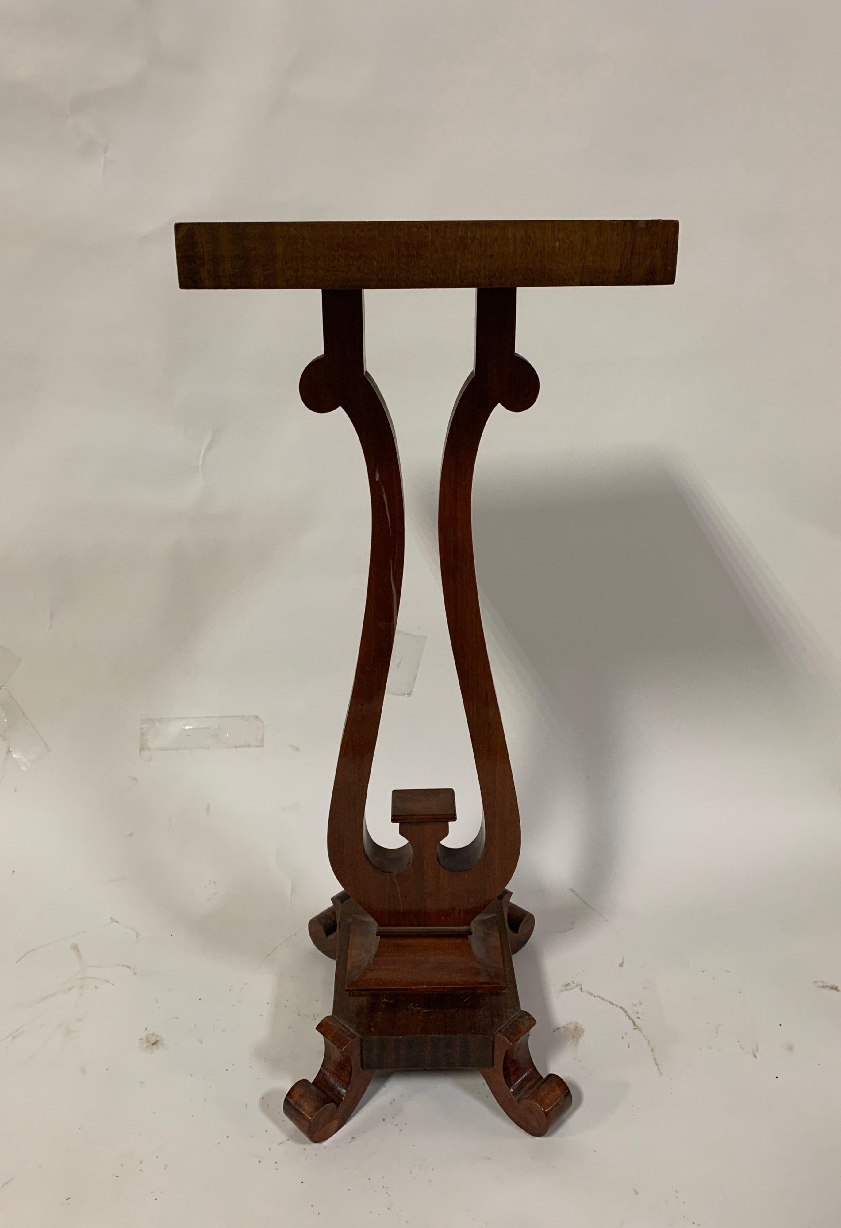 A mahogany pedestal or plant stand from the Empire Revival period, USA, circa 1920.